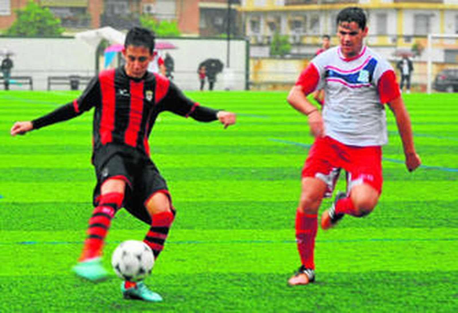 Un jugador del Séneca intenta despejar el esférico en presencia de un jugador del Siempre Alegres.