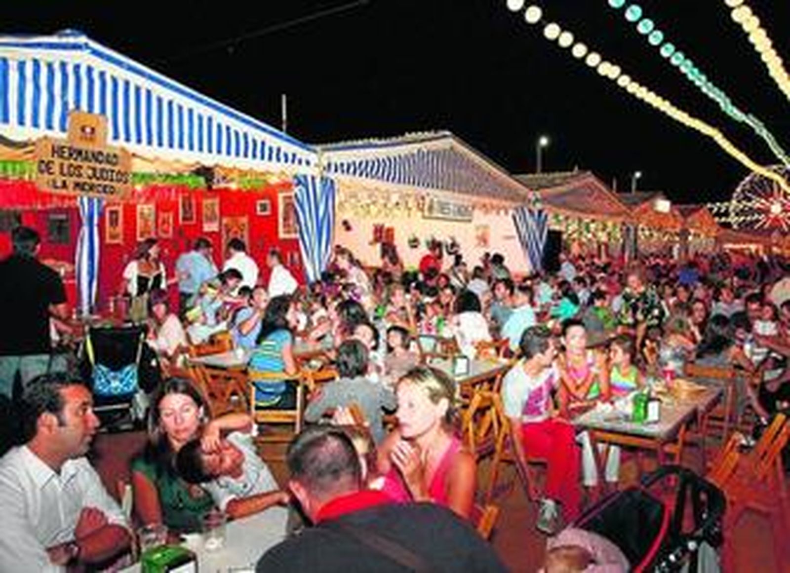 1. La multitud se agolpa en las terrazas de las casetas de las hermandades. 2. El Recinto Colombino repleto de visitantes. 3. Calle Marismas del Titán. 4. El ferial posee 13 tómbolas y bingos. 5. Caseta de los mayores . 6 y 7. Un total de 21 bares y chocolaterías y 31 puestos variados se pueden encontrar en el recinto.  8. Caseta de la Hermandad de Estudiantes.
