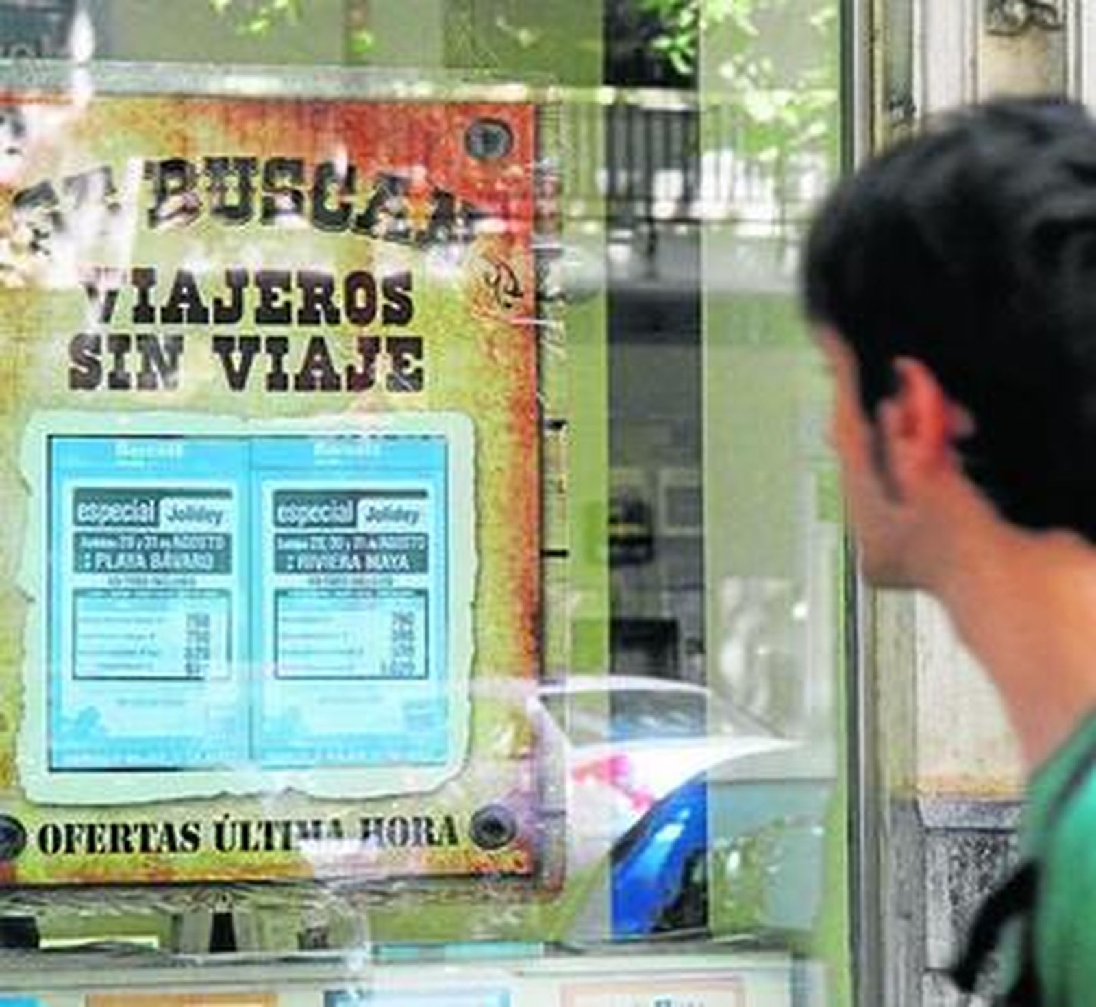 Un joven mira una oferta en una agencia cordobesa.