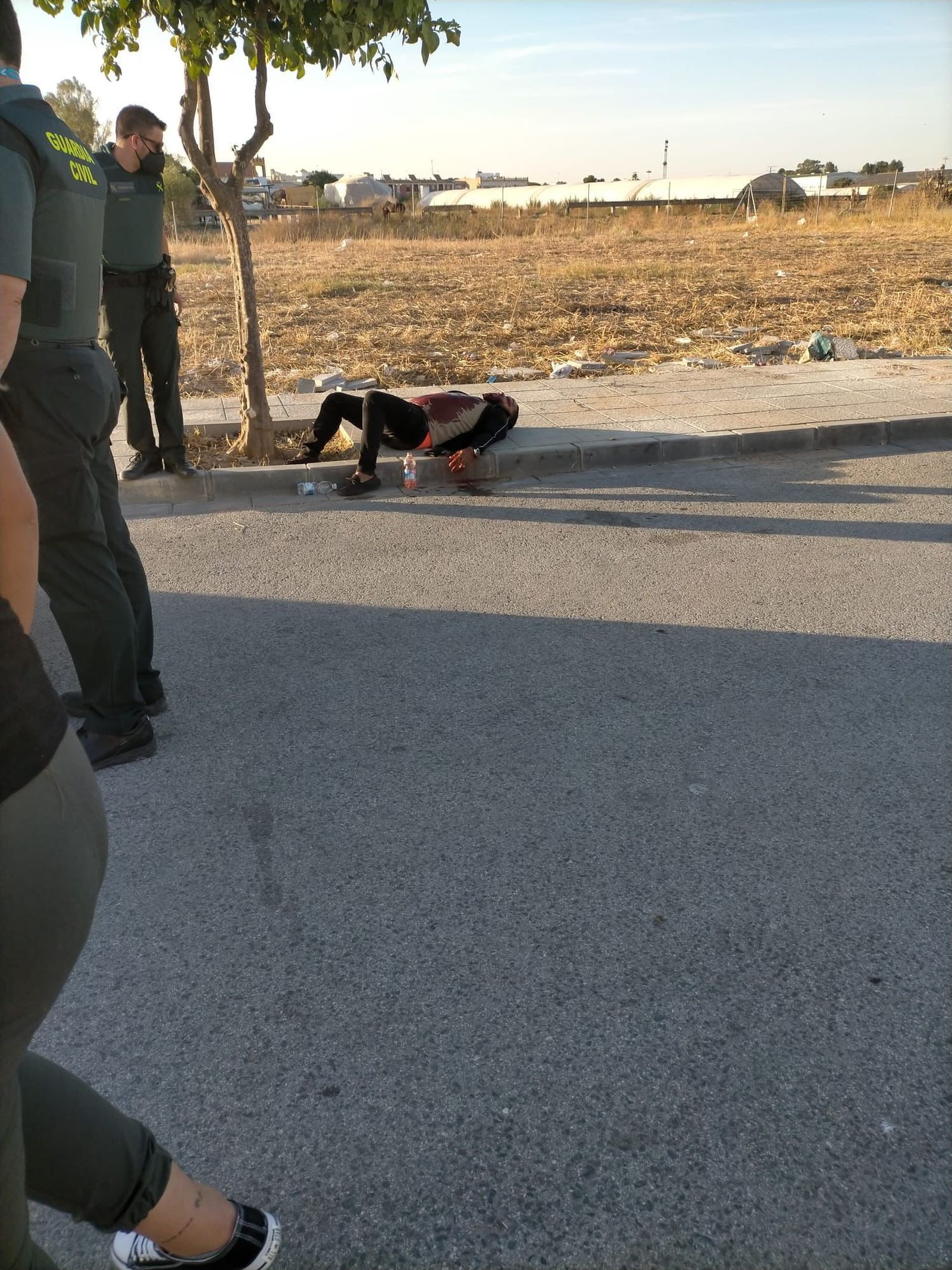 Los agentes atienden a la víctima, que está tendida en el suelo.