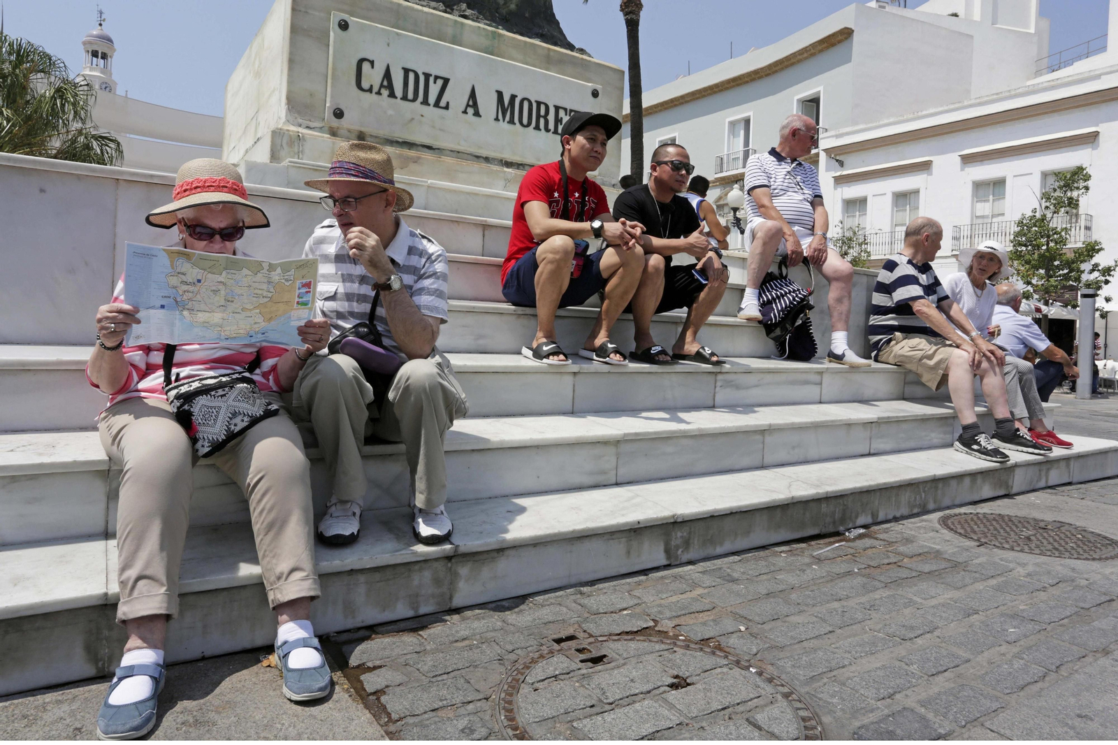 Varios turistas descansan en la escalinata del monumento a Moret en Cádiz, en una imagen de archivo.