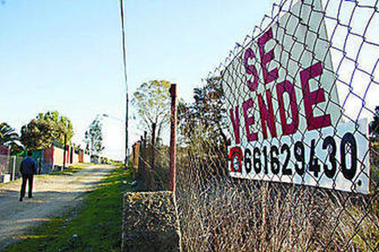Una parcela con un cartel de 'se vende' en la urbanización de Las Minas, en Castilblanco.