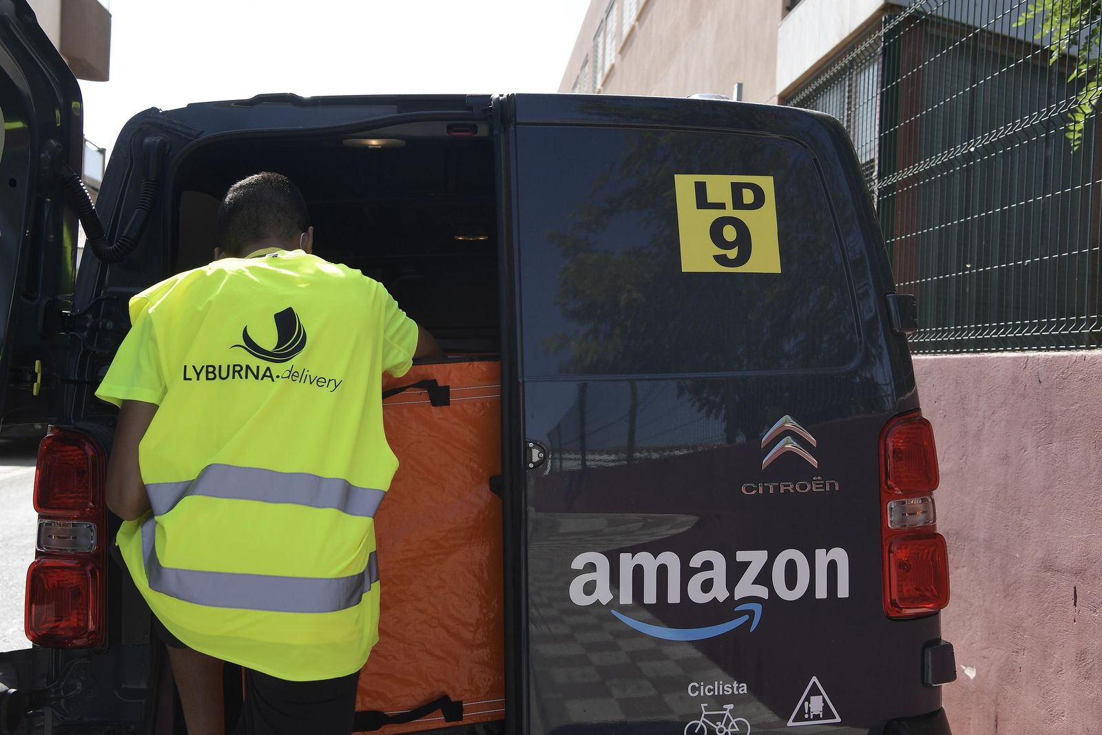 Un repartidor entra en la furgoneta de reparto de Amazon.