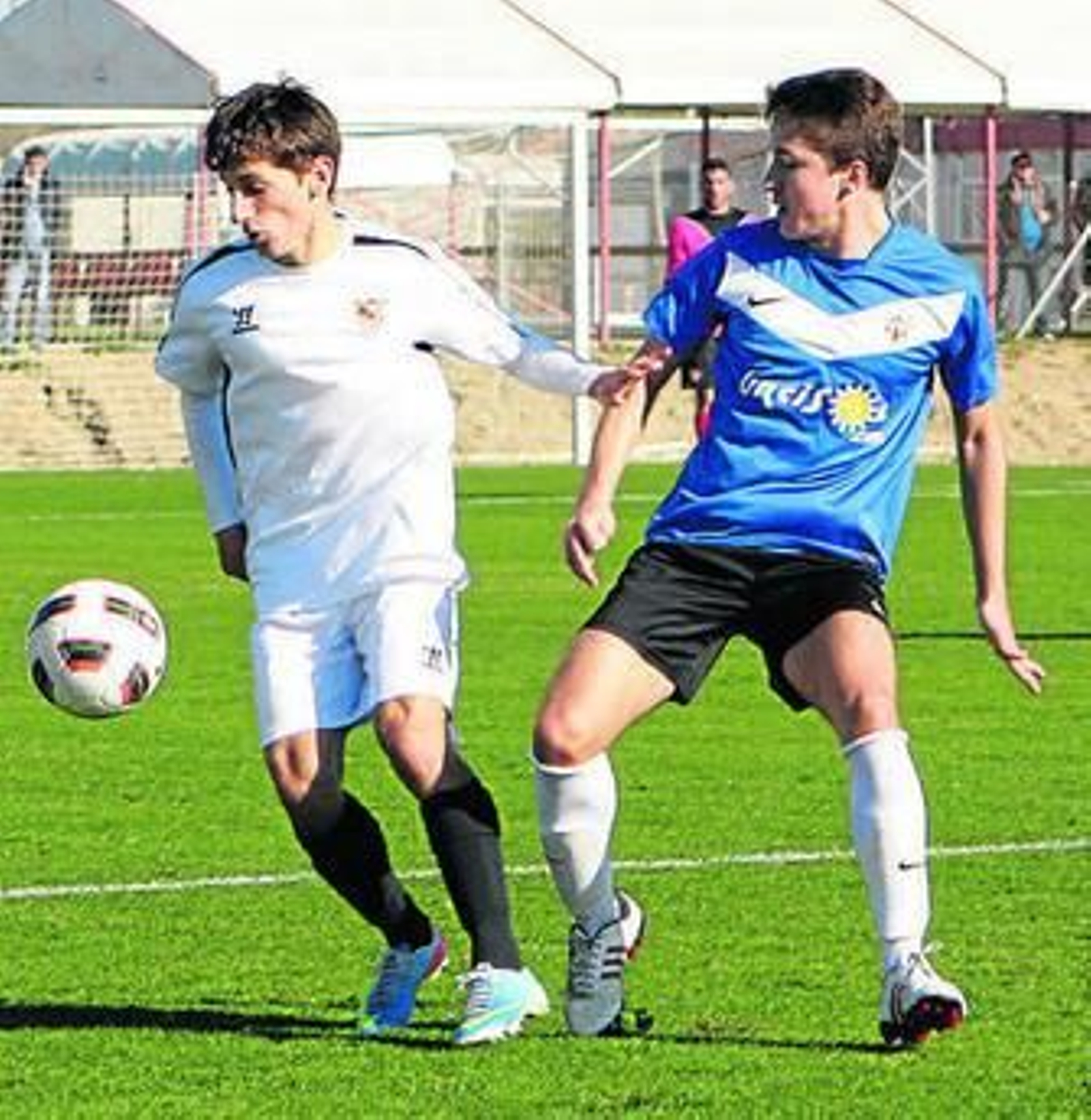 El sevillista Juanje trata de llevarse un balón ante un rival.