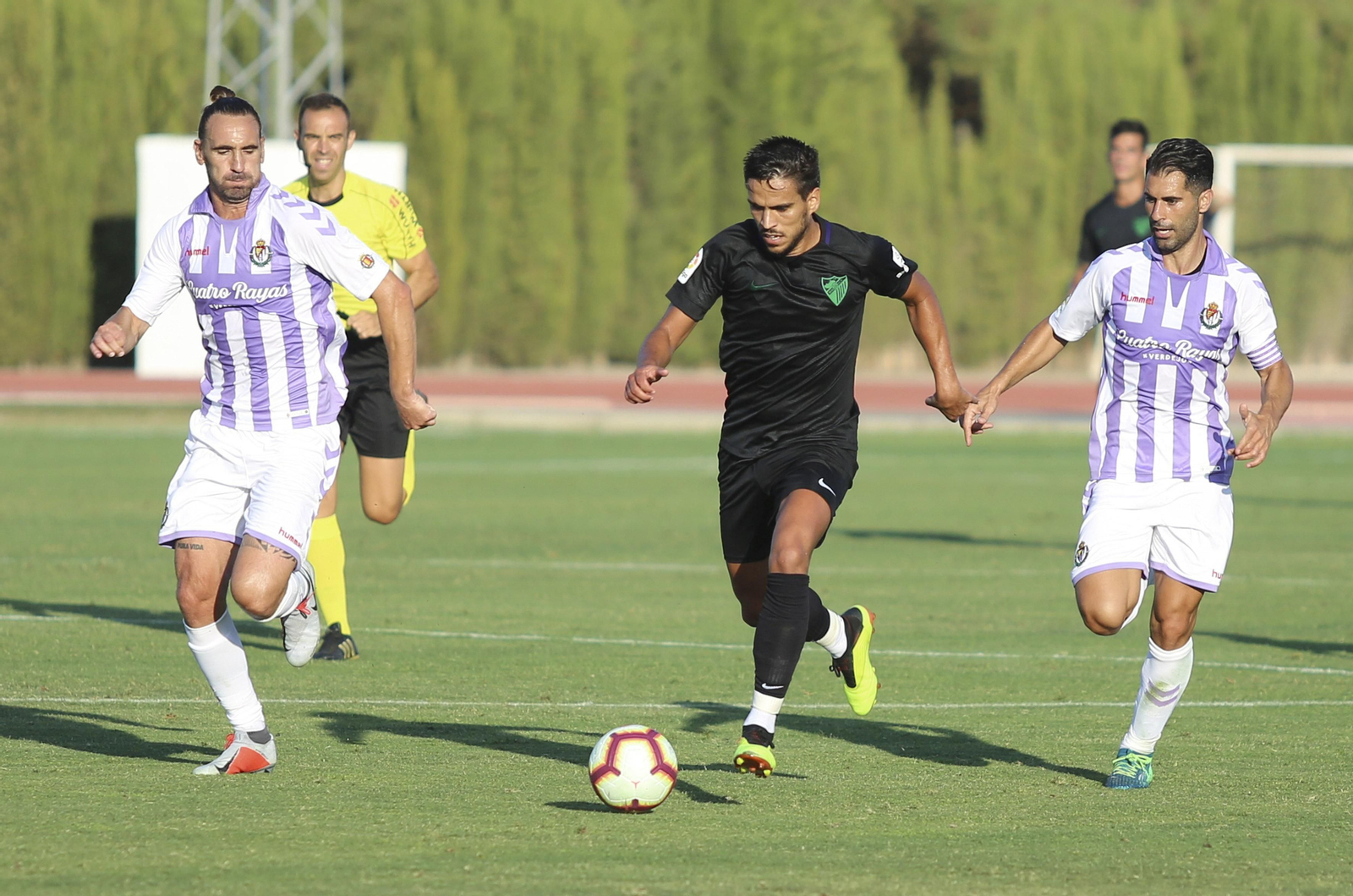 Recio conduce el balón ante dos jugadores del Valladolid en el amistoso disputado la pasada pretemporada.