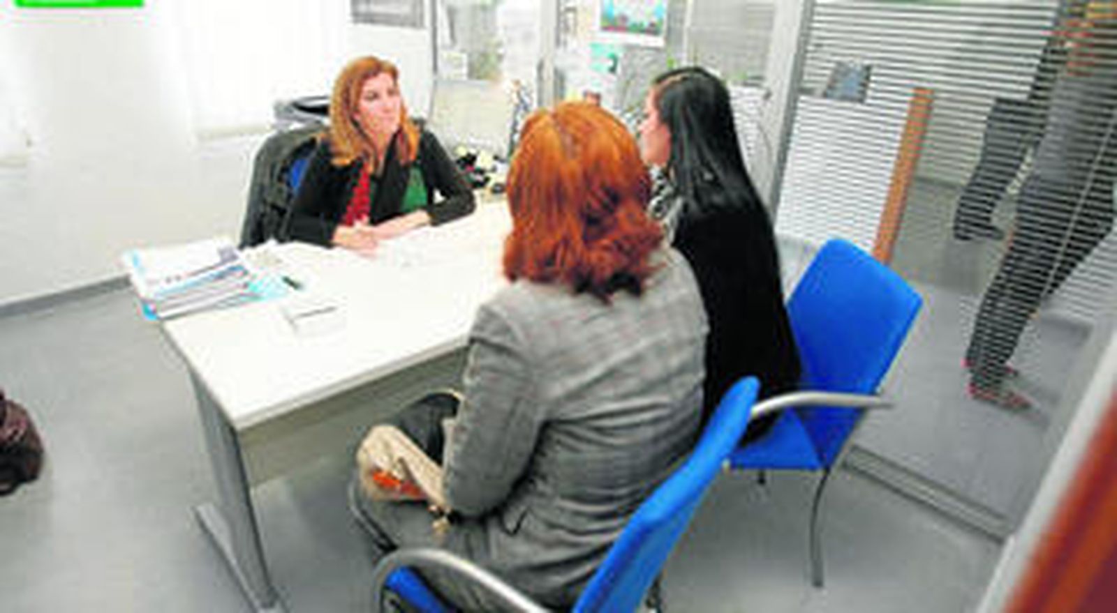 Una de las técnicos del CADE atiende a unas vecinos que requieren información para la apertura de una posible empresa.