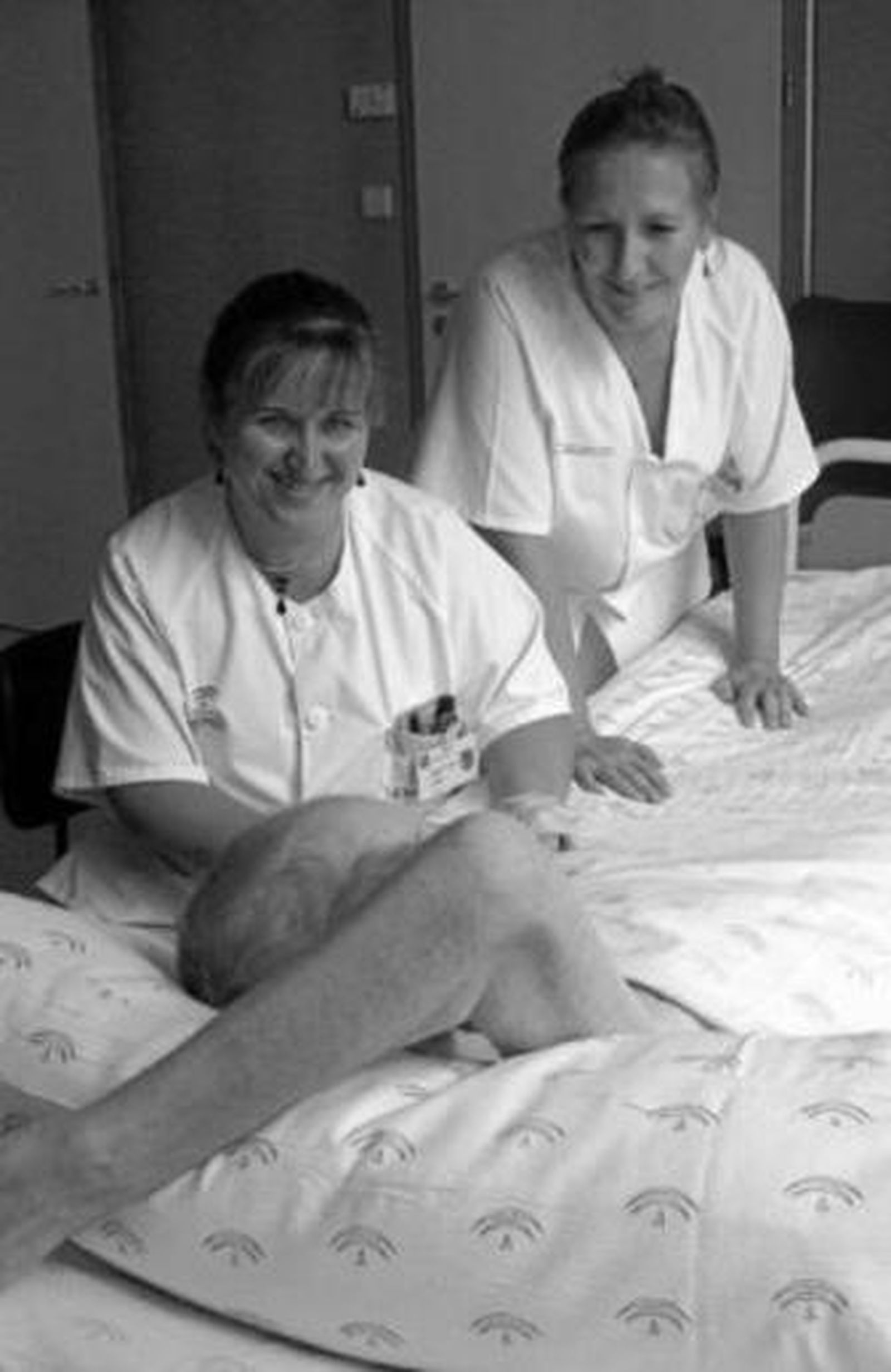 Dos enfermeras con un paciente.