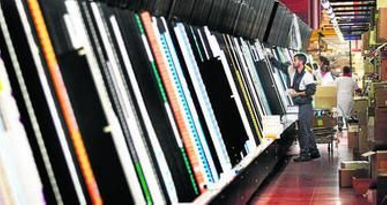 Un trabajador repone medicamentos en el robot de Cofarán que prepara los encargos para las farmacias.