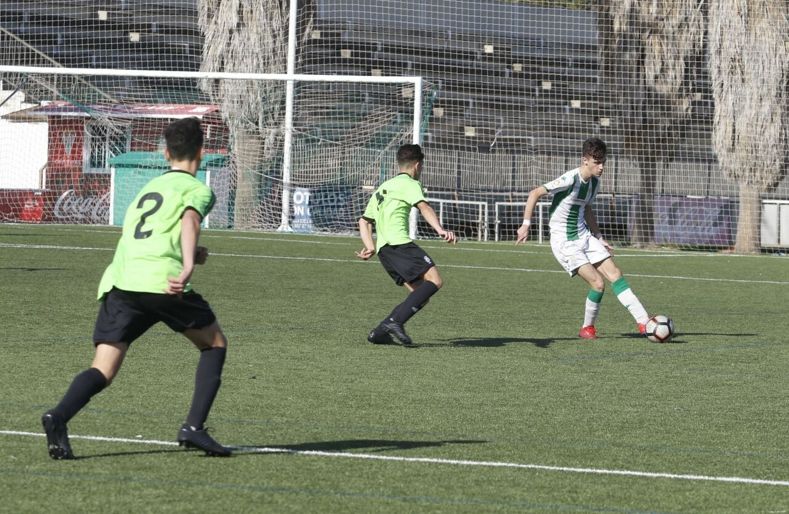 Un jugador del Córdoba pasa el esférico en presencia de un jugador del Recreativo de Huelva.