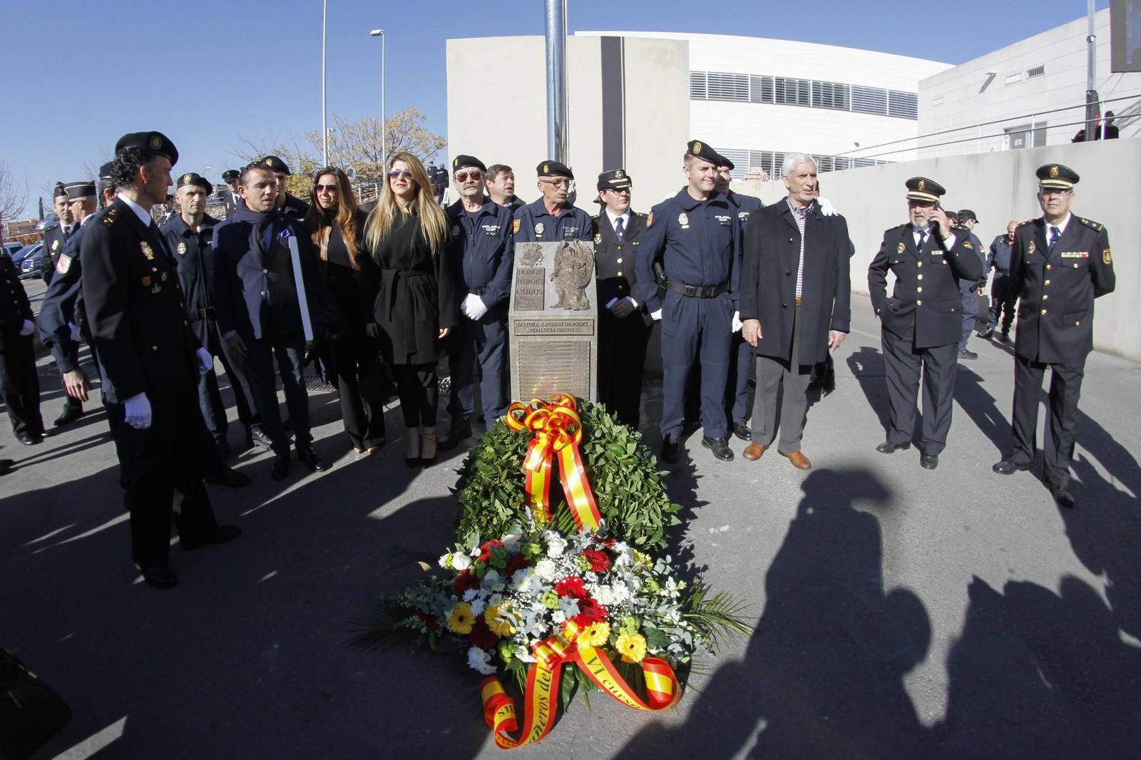 Estefanía Vega y Gema de los Ríos, acompañadas de representantes de la Policía, posan junto al monolito.