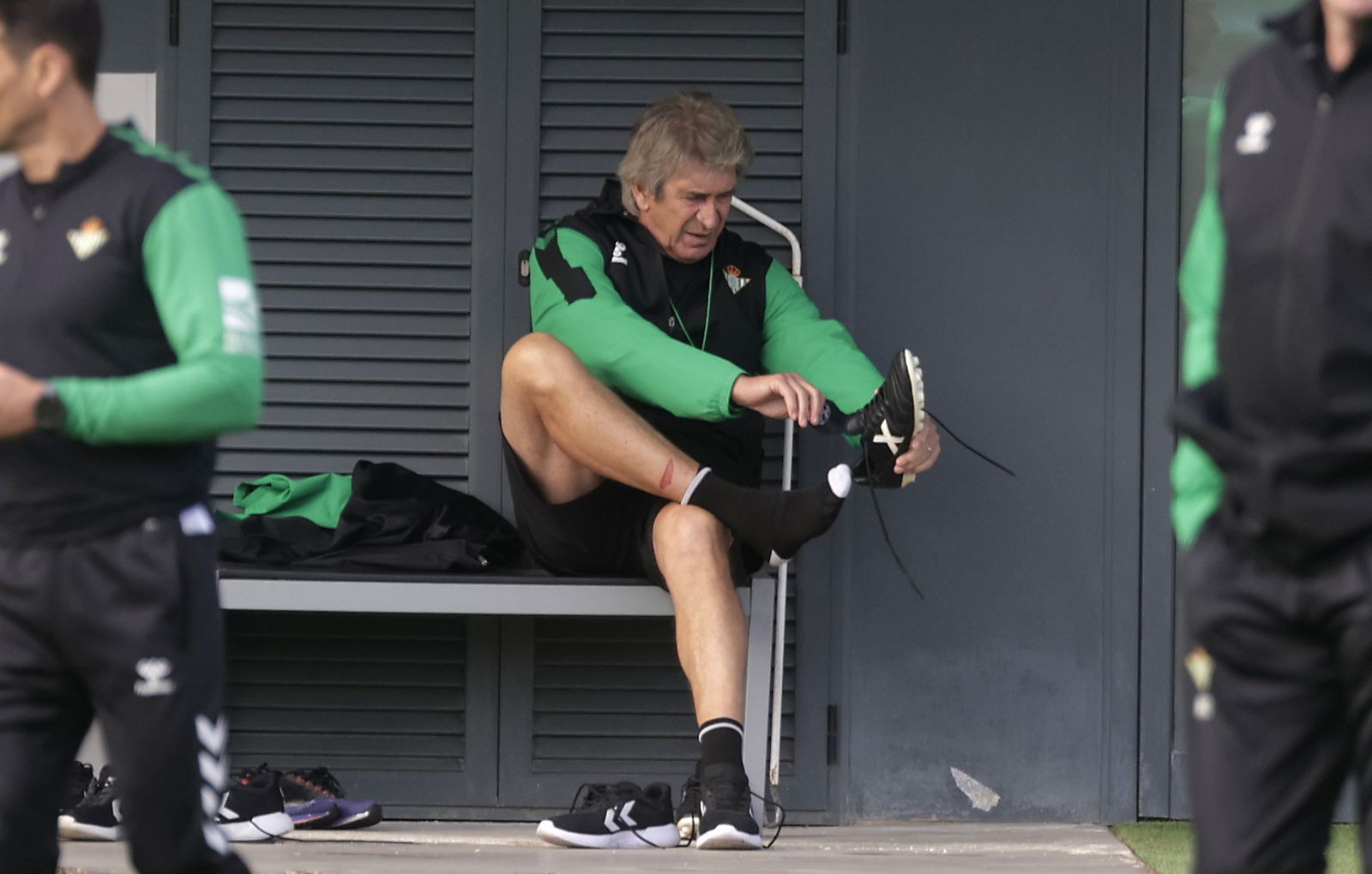 Pellegrini se calza las botas antes de un entrenamiento.