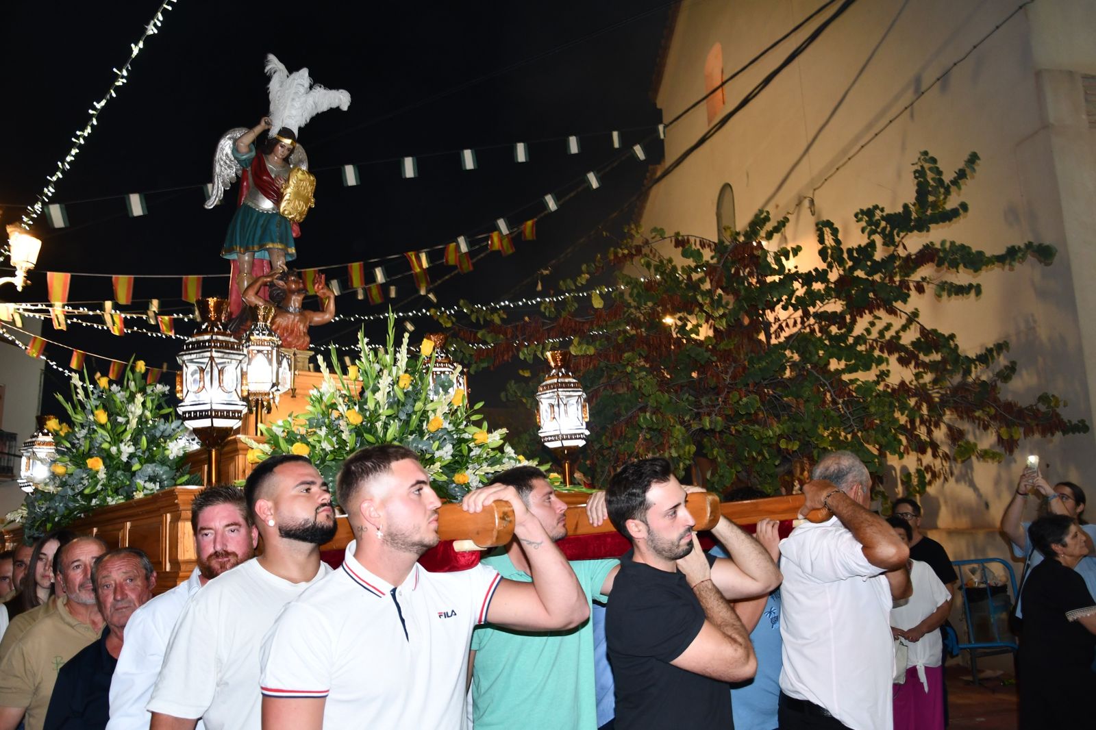 Momento de la procesión de la imagen de San Miguel Arcángel por las calles de Celín