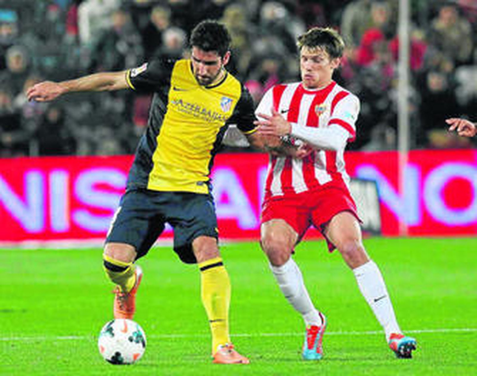 Raúl García intenta controlar el balón ante el acoso de Dubarbier.