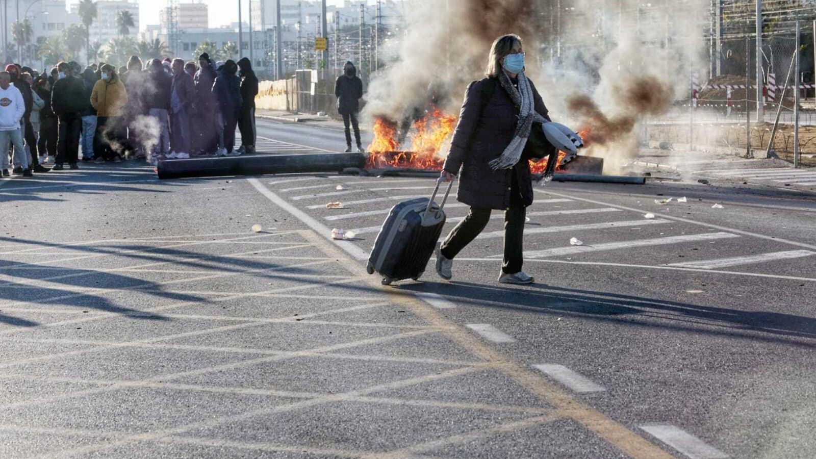 Una mujer arrastra su maleta por la avenida de Astilleros para llegar a la estación de autobús.
