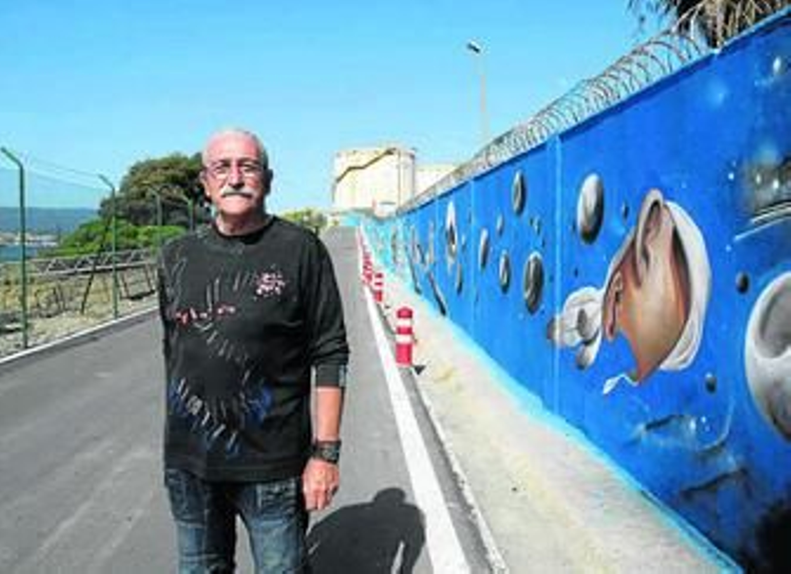 Imagen de Antoni Gabarre junto a los muros exteriores pintados en la refinería Gibraltar-San Roque.