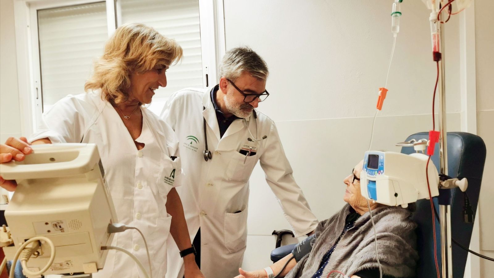 El jefe de sección de Medicina Interna en el Hospital El Tomillar, Dr. Salvador Vergara, junto a la enfermera Carmen Buiza con una paciente a la que se le está realizando una transfusión sanguínea.
