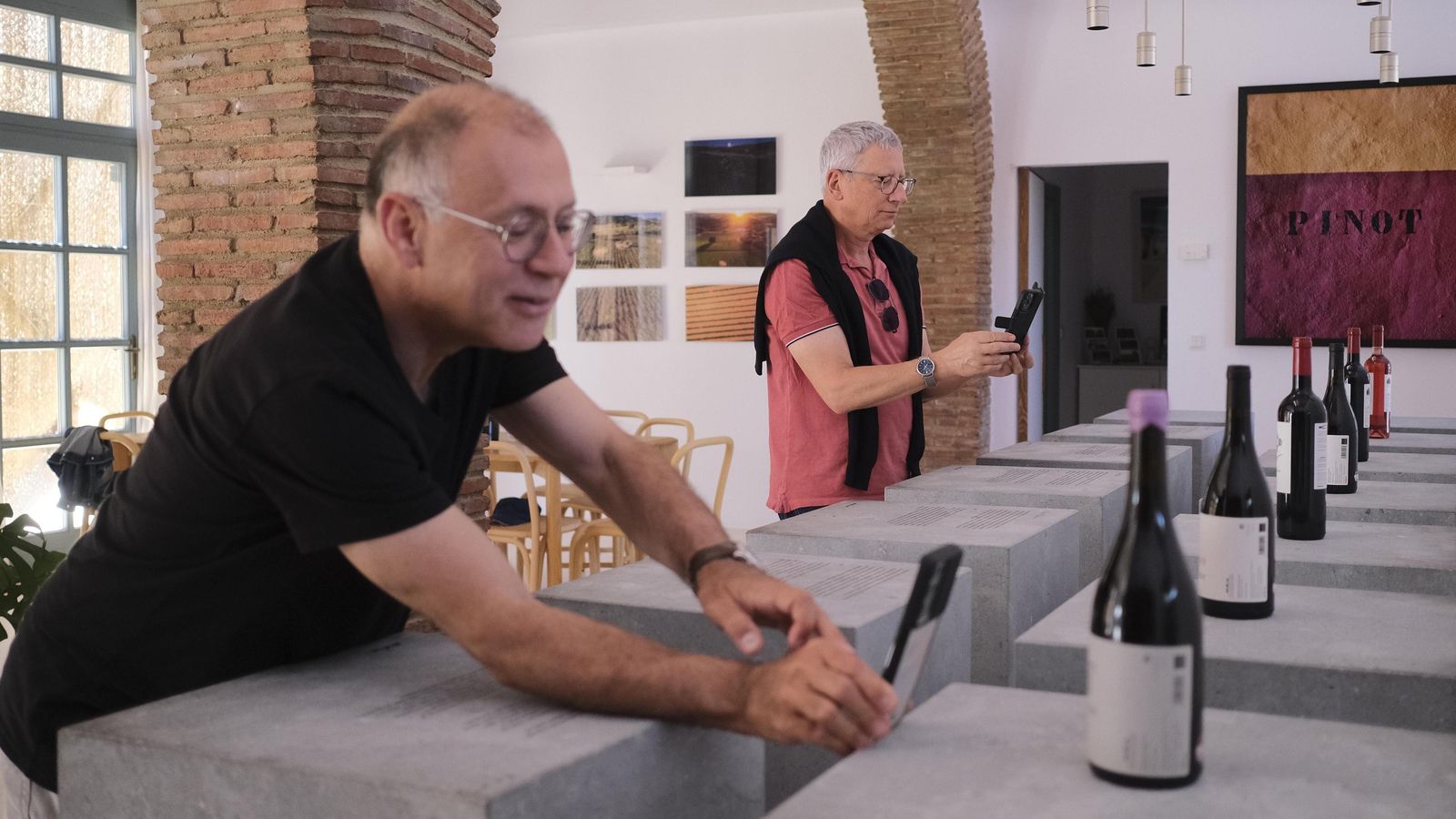 Dos turistas toman fotos de los vinos de la bodega Los Aguilares. Dos turistas toman fotos de los vinos de la bodega Los Aguilares.