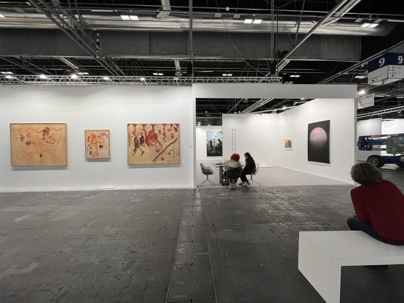 Juana de Aizpuru en su expositor en ARCO ante las tres pinturas de Claramunt.