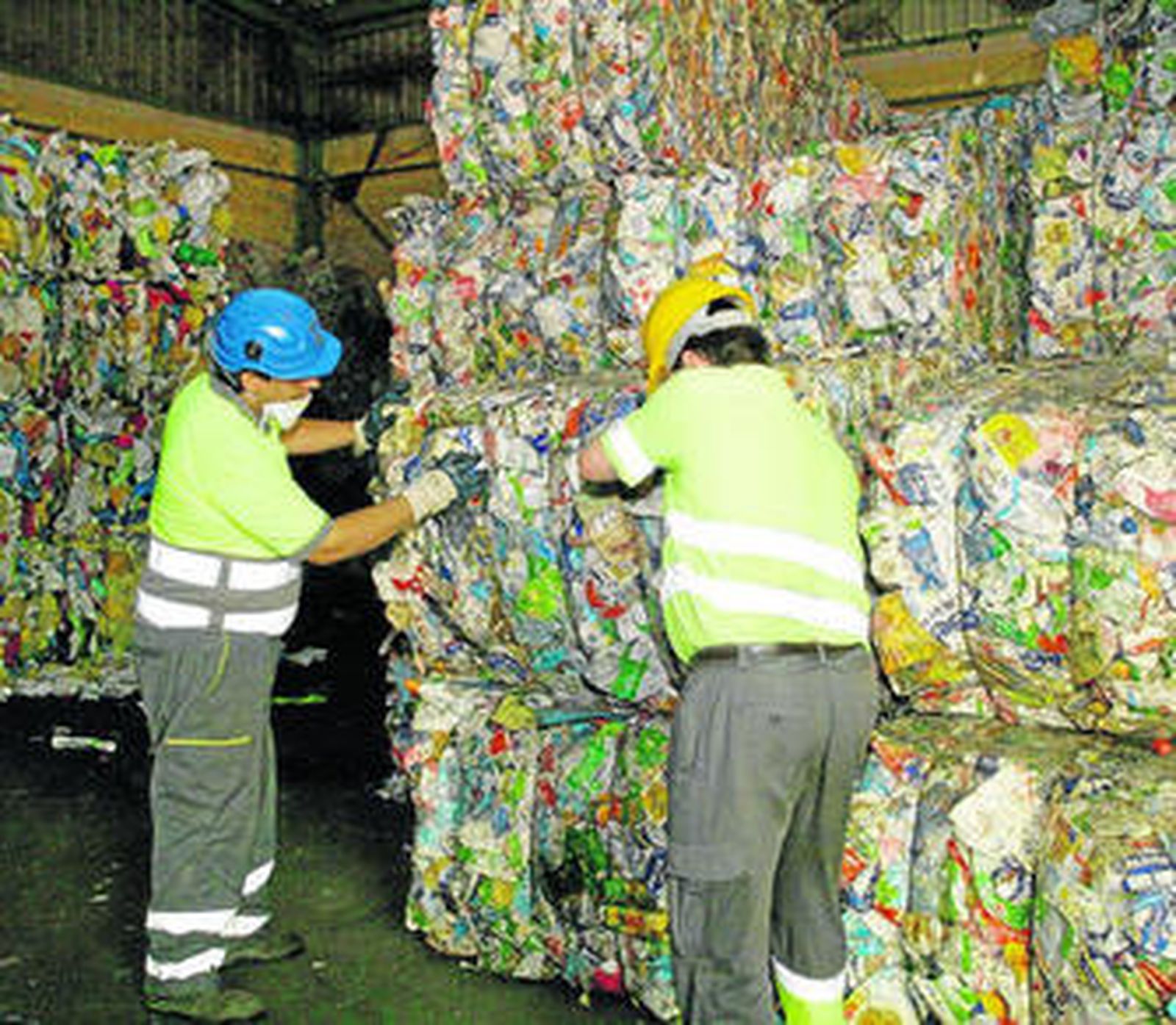 Dos hombres trabajan en una planta de reciclado en Almería.