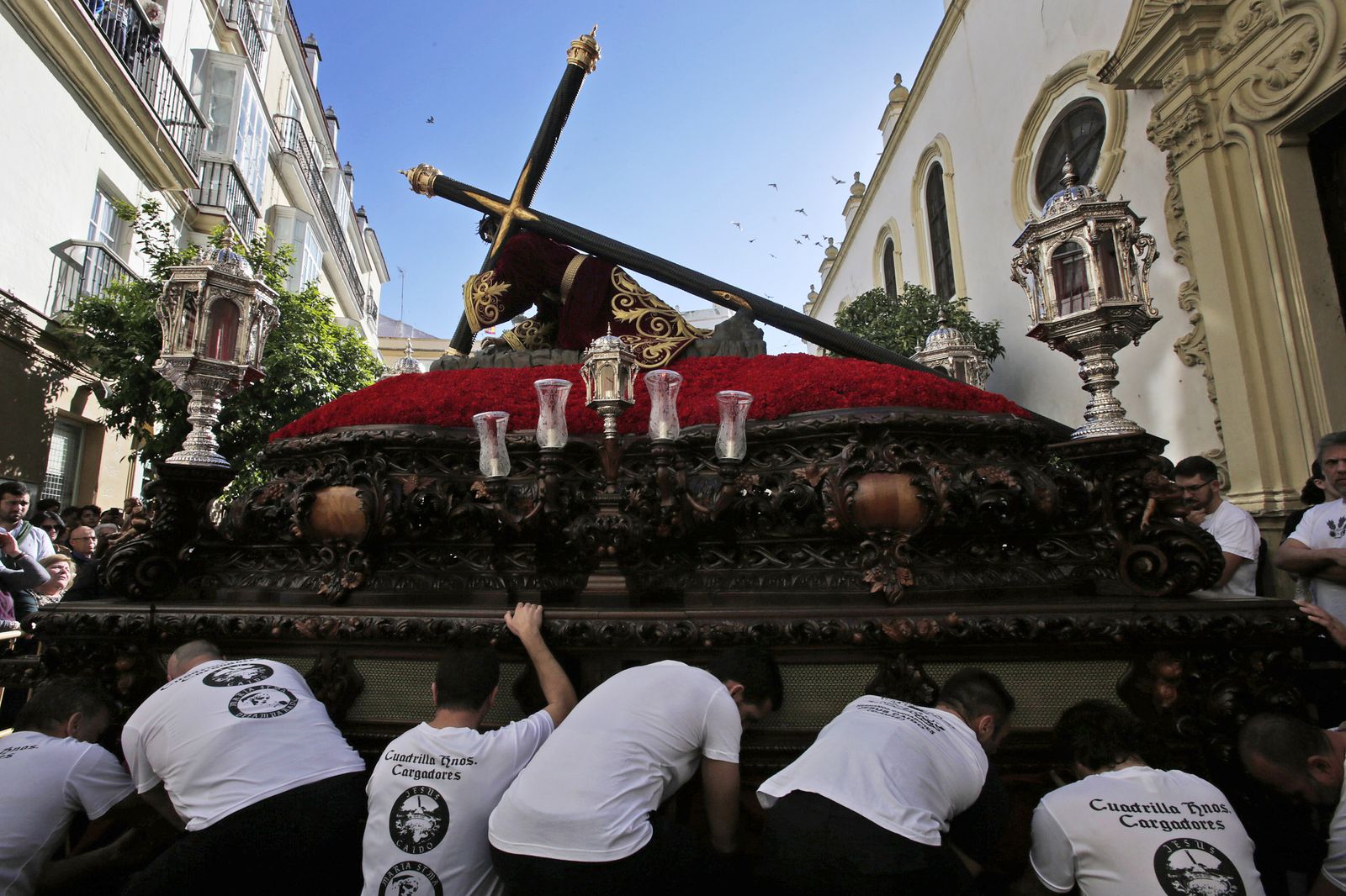 Los cargadores del Caído se preparan para la maniobra de levantar el paso tras superar la puerta de San Antonio del templo franciscano.