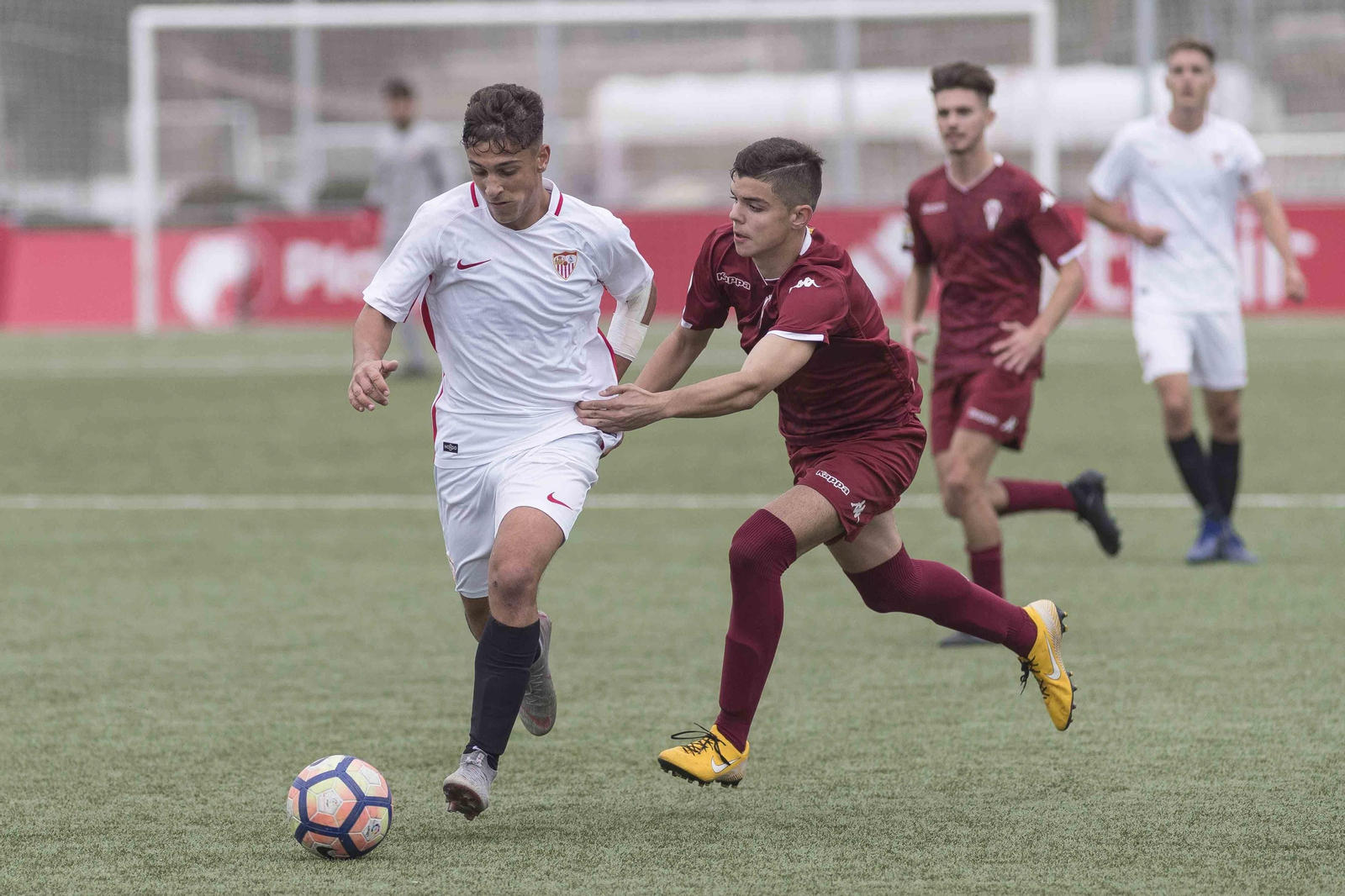 El sevillista Zarzana trata de zafarse de un rival.