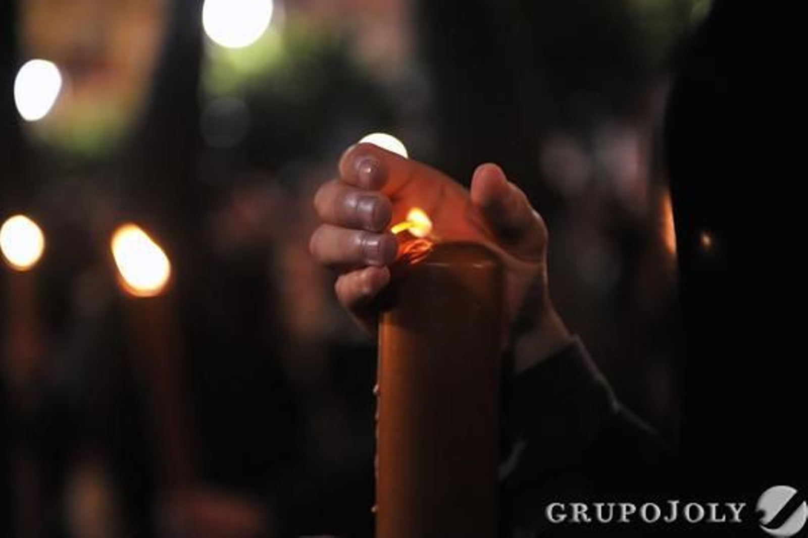 Un nazareno protege la llama de su cirio del viento.

Foto: Juan Carlos Vazquez