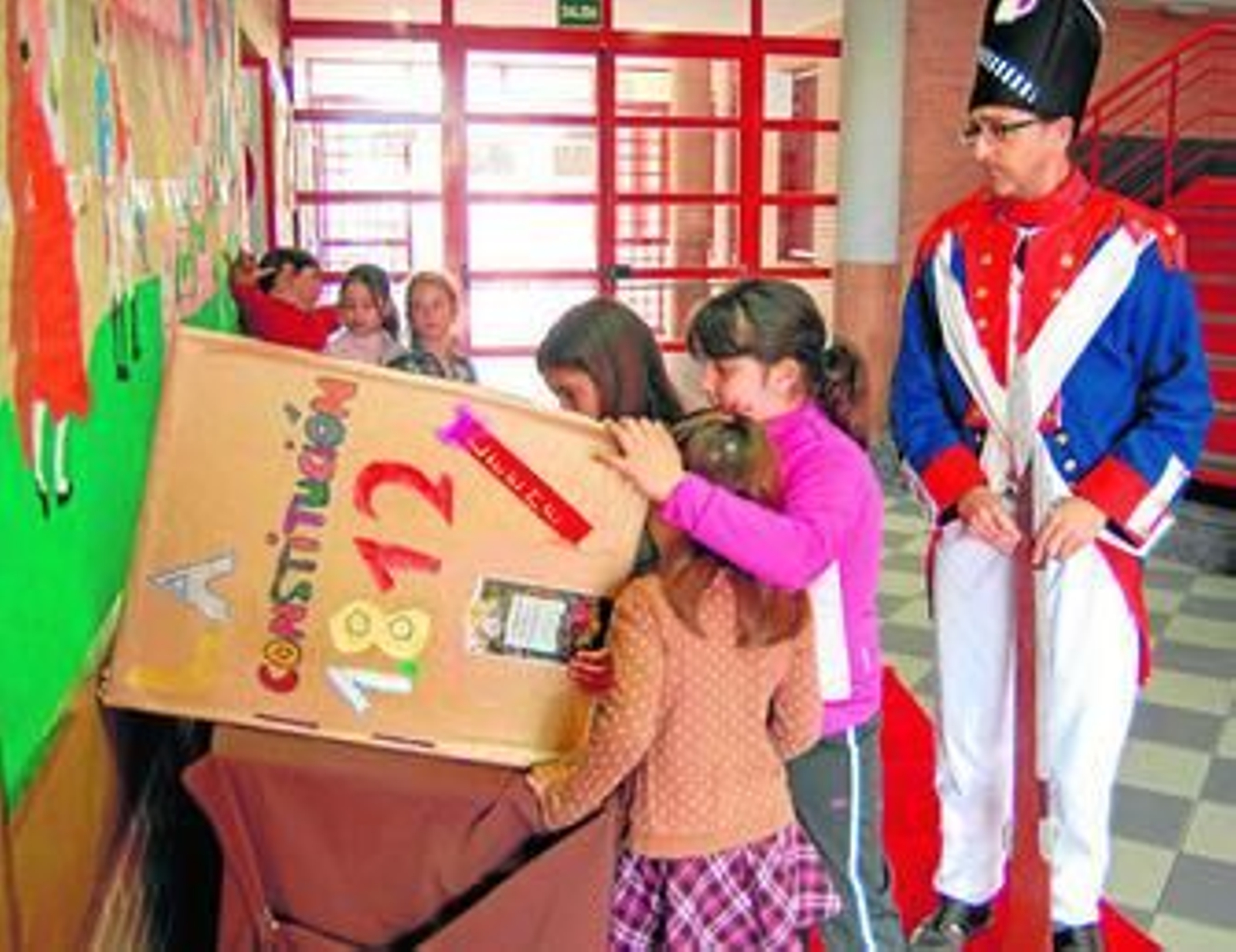 Un padre ataviado con un uniforme de soldado francés junto a alumnas del centro.