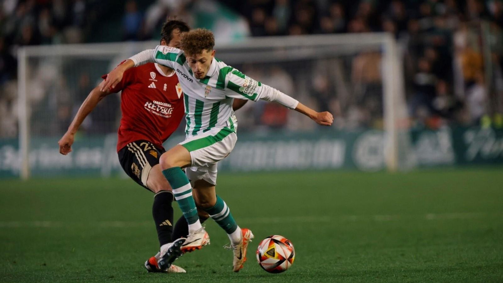 Simo es frenado por Tomás Pina en el tramo final del Córdoba CF - Murcia.