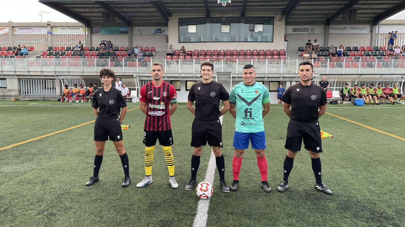 Los capitanes de ambos equipos posan con el trío arbitral antes del encuentro.
