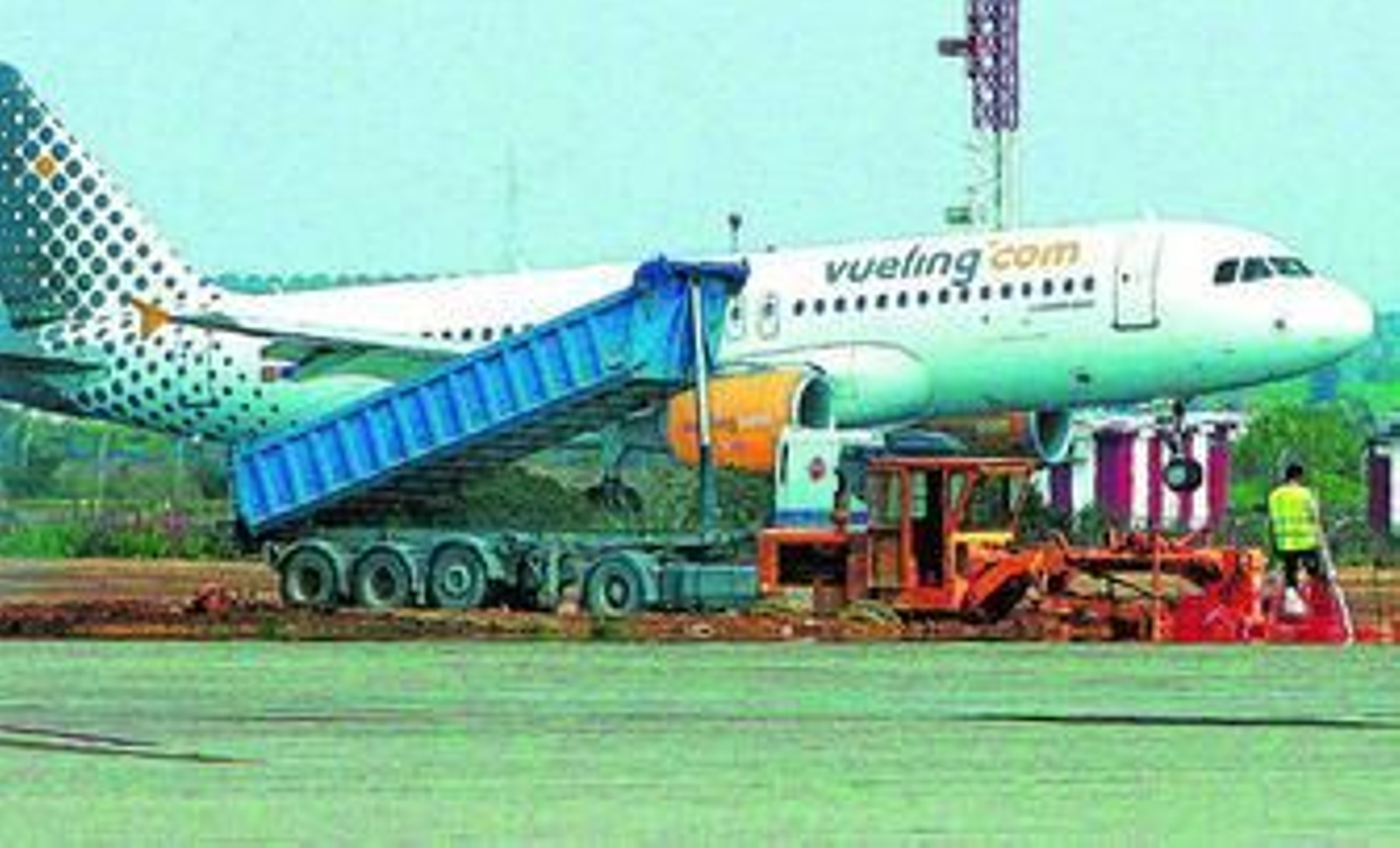 Un avión de Vueling con rumbo a Barcelona despega del aeropuerto de Jerez mientras se acometen obras junto a la pista.