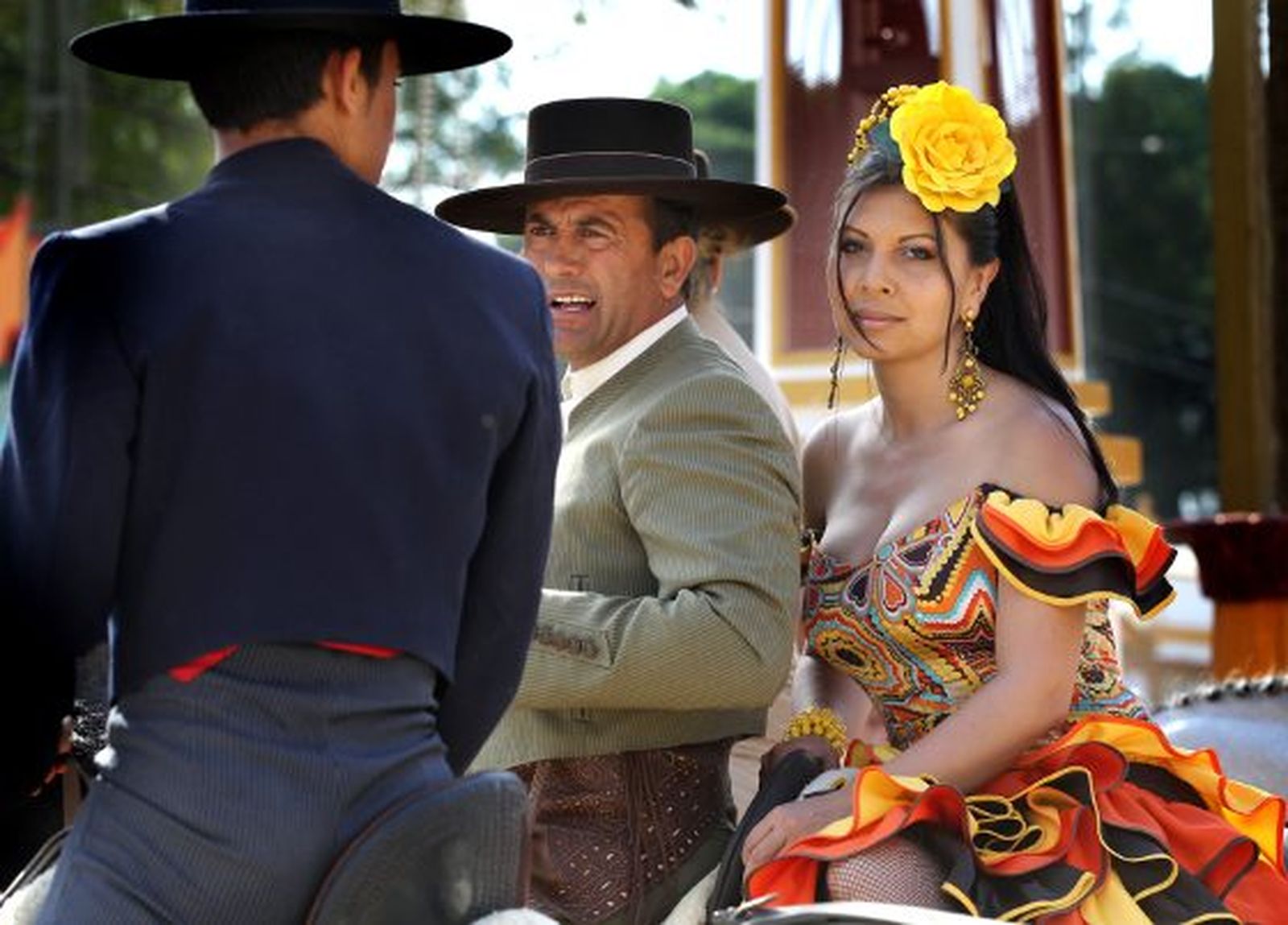 Dos caballistas -uno de ellos con una mujer vestida de gitana a la grupa- intercambian impresiones en el Real.

Foto: miguel ángel gonzález