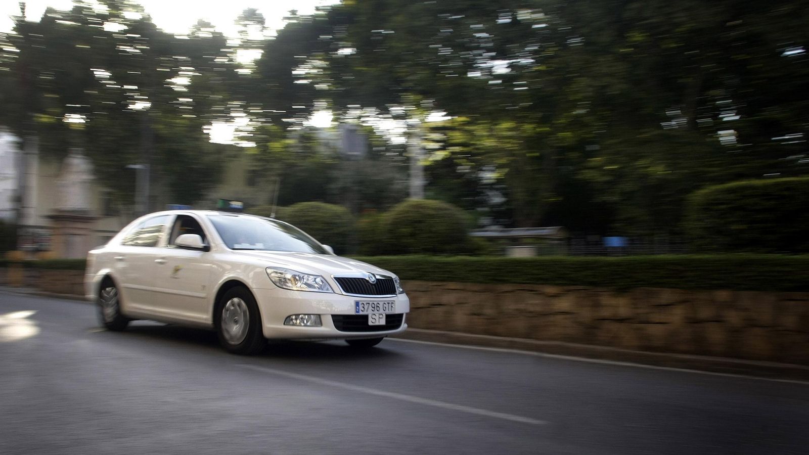 Un taxi circulando frente al parque María Cristina, de Algeciras.