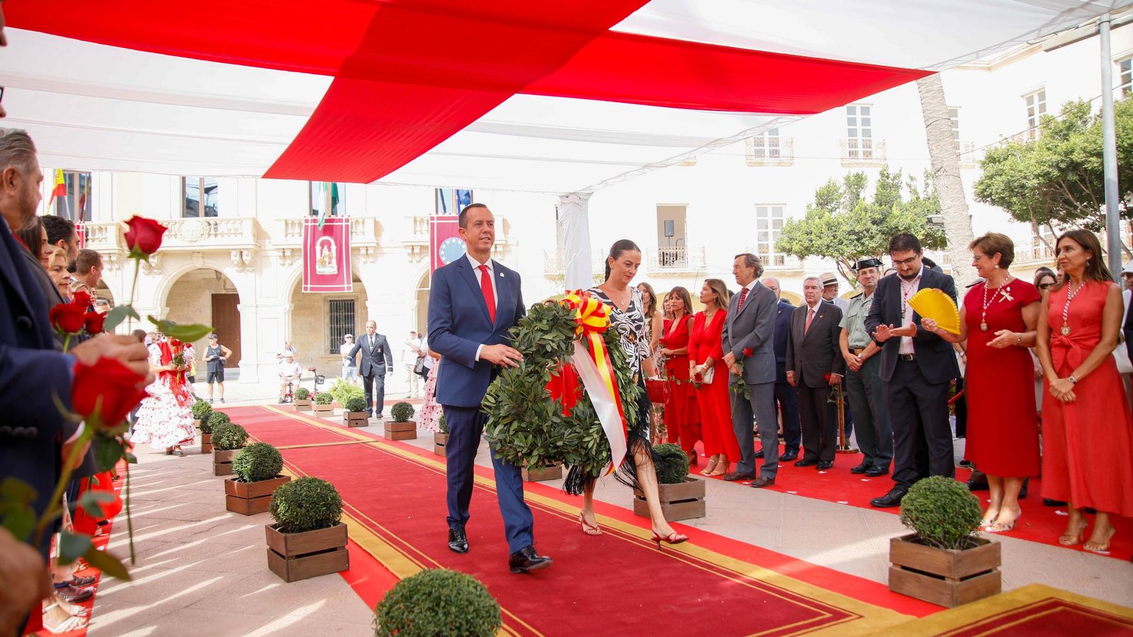 El subdelegado del Gobierno y la delegada de la Junta de Andalucía entregan una corona de laurel.