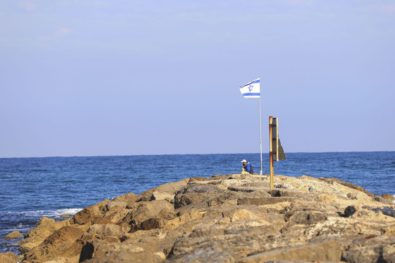 Un hombre descansa en la playa tras la primera noche sin alarmas continuas en Tel Aviv.