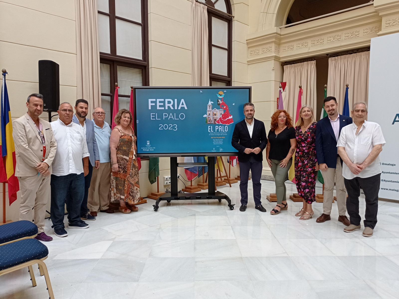 Carlos Conde y colaboradores junto al carte del la Feria El Palo 2023