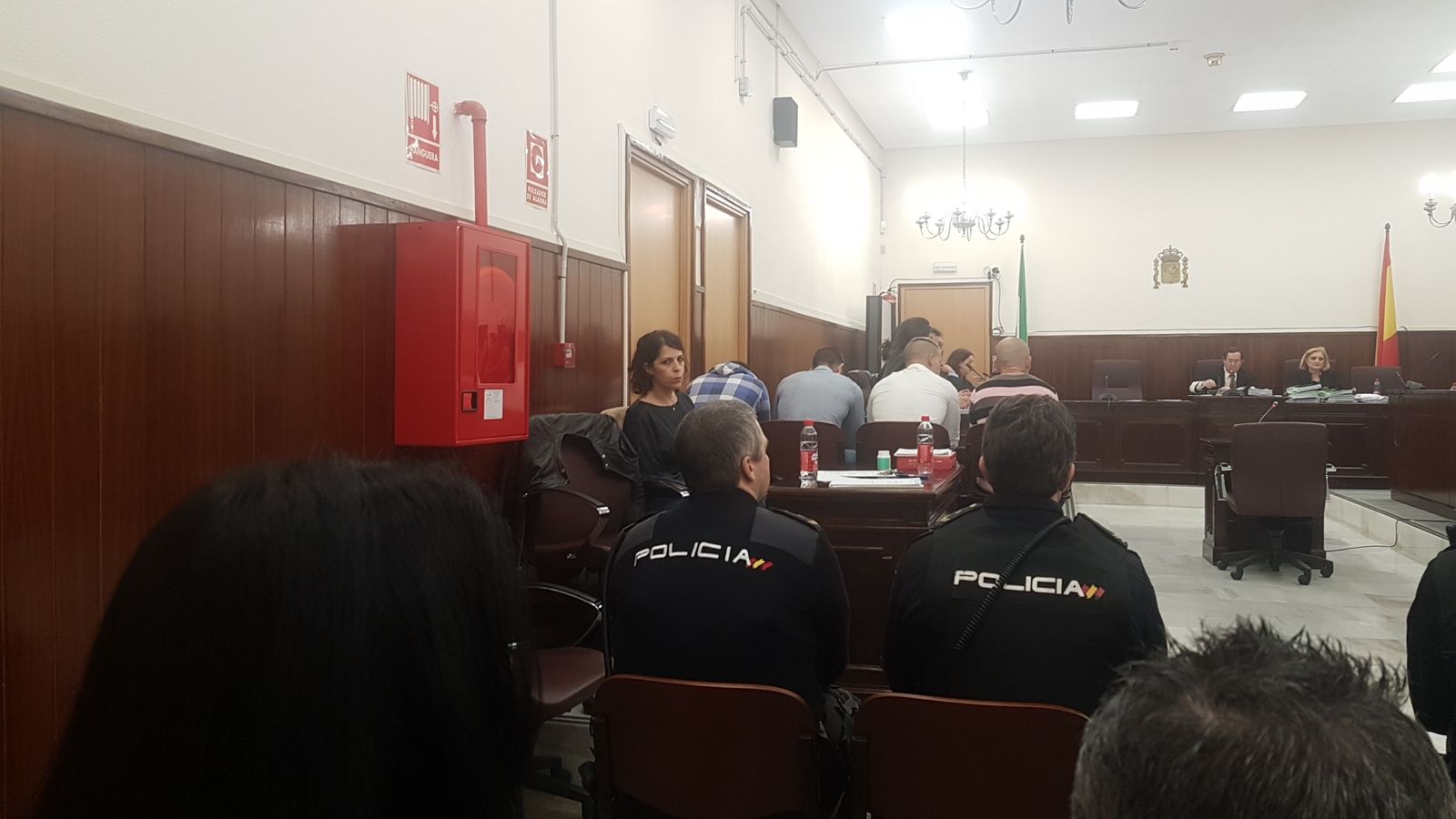 Los cuatro acusados, de espaldas, antes del inicio de la lectura del veredicto.