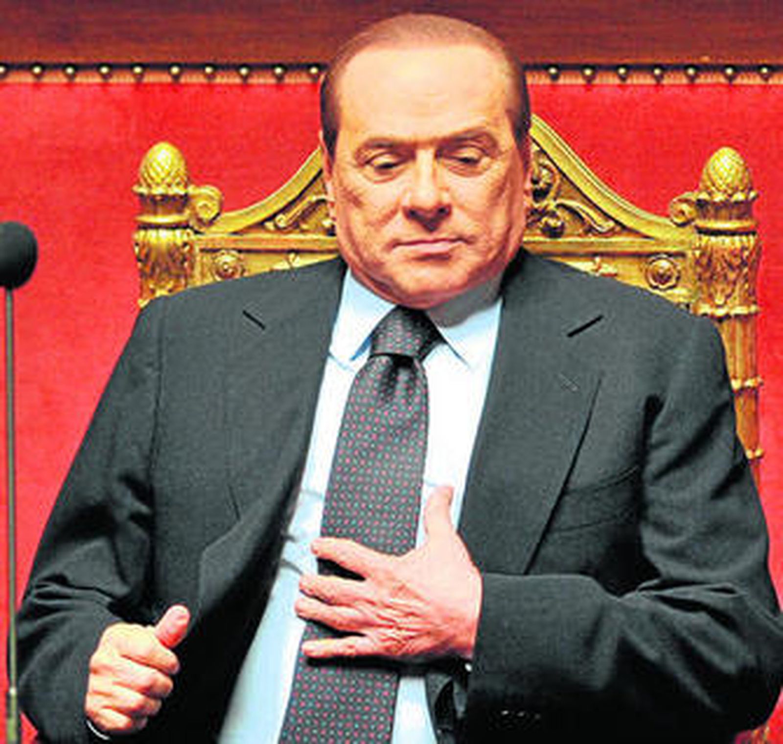 El primer ministro Berlusconi se ajusta la corbata tras dirigirse al Senado.