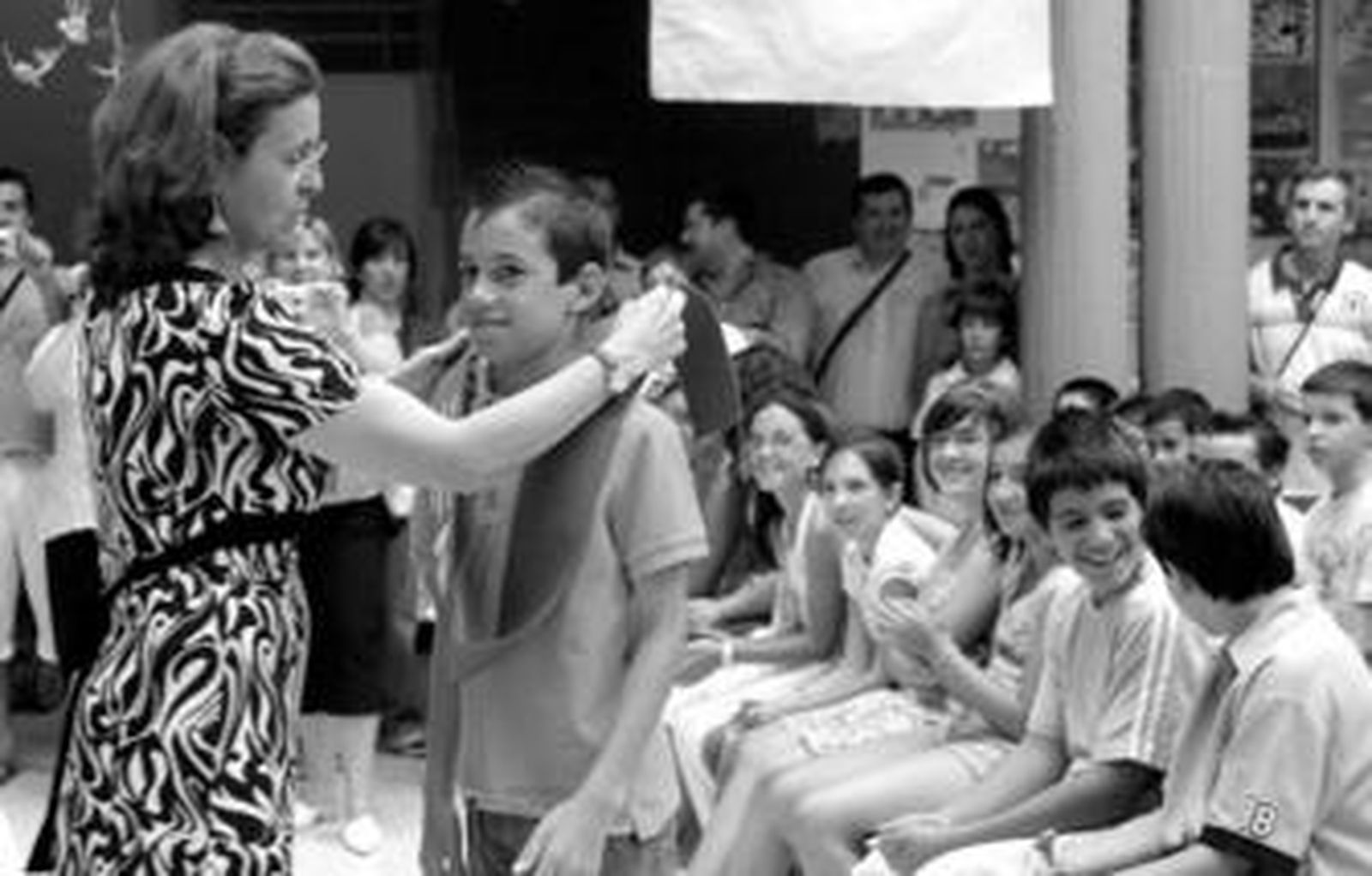 Los profesores se emocionaron al colocar las bandas sobre los hombros de sus alumnos.