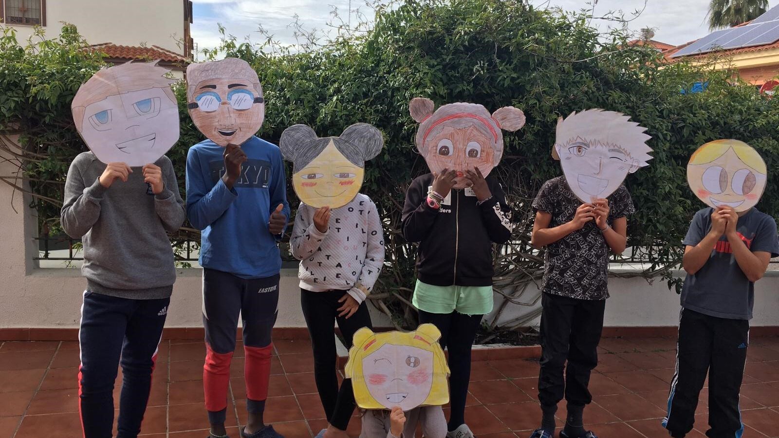 Menores de un hogar posan durante el confinamiento con máscaras.