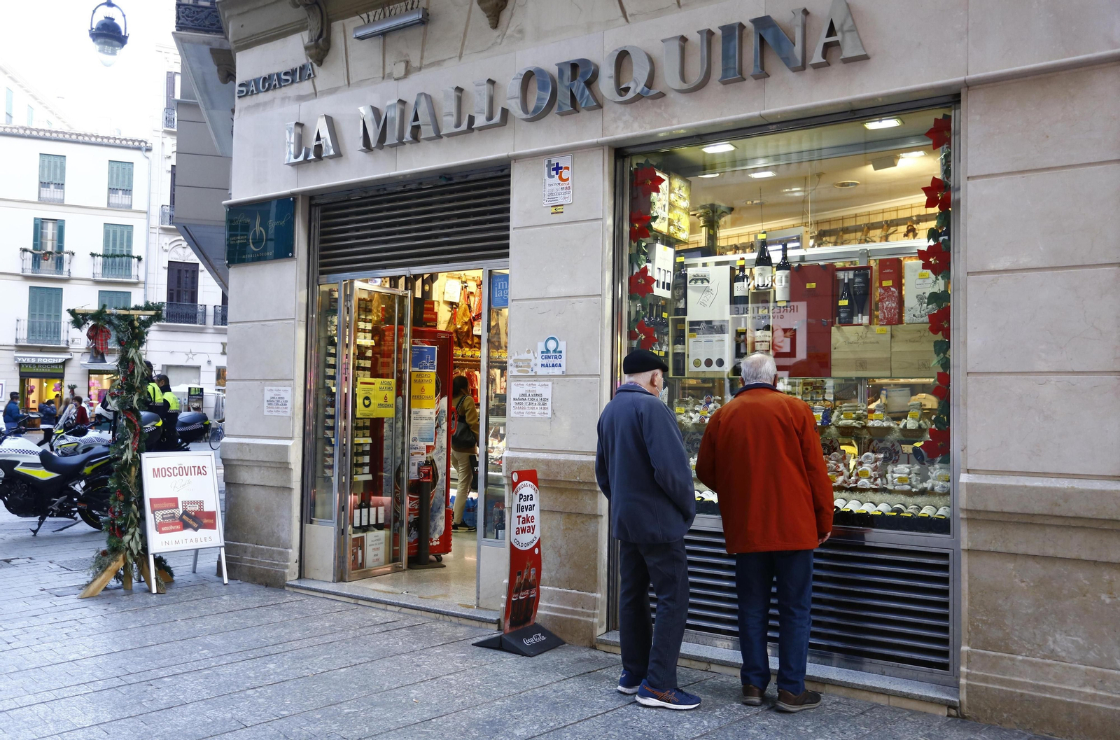 Dos clientes en el escaparate de La Mallorquina.