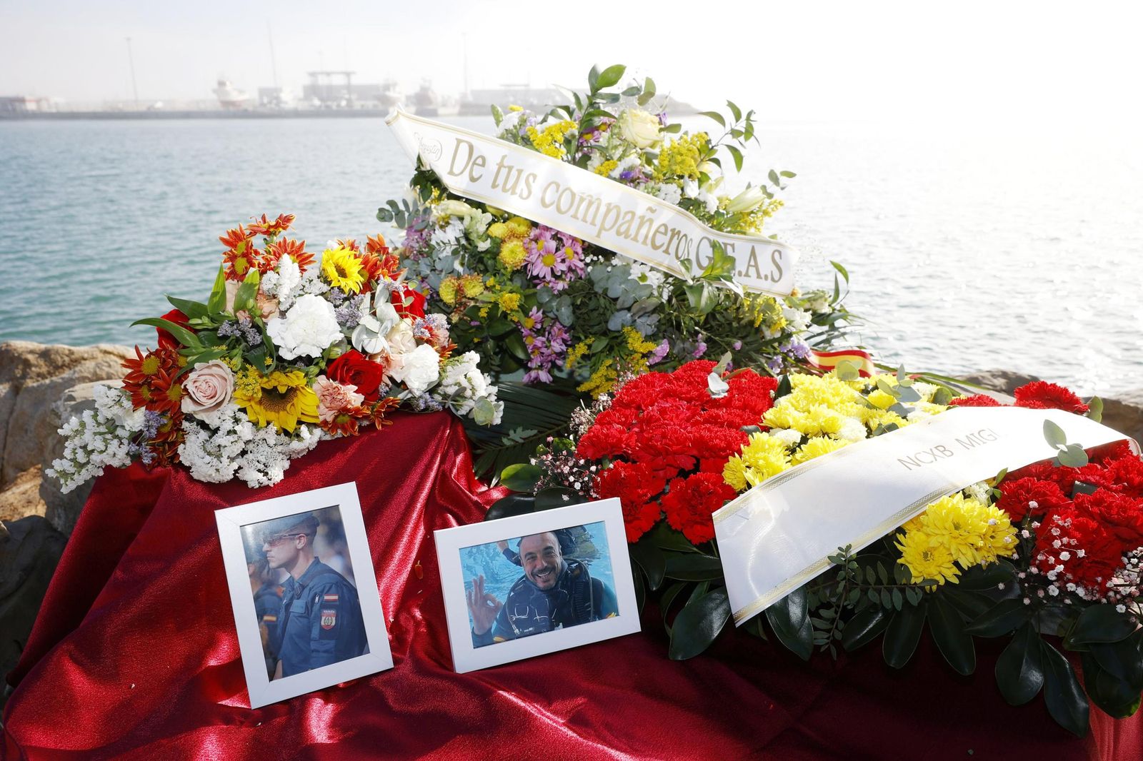 Varios ramos de flores recuerdas a los guardias civiles muertos en el puerto de Barbate.