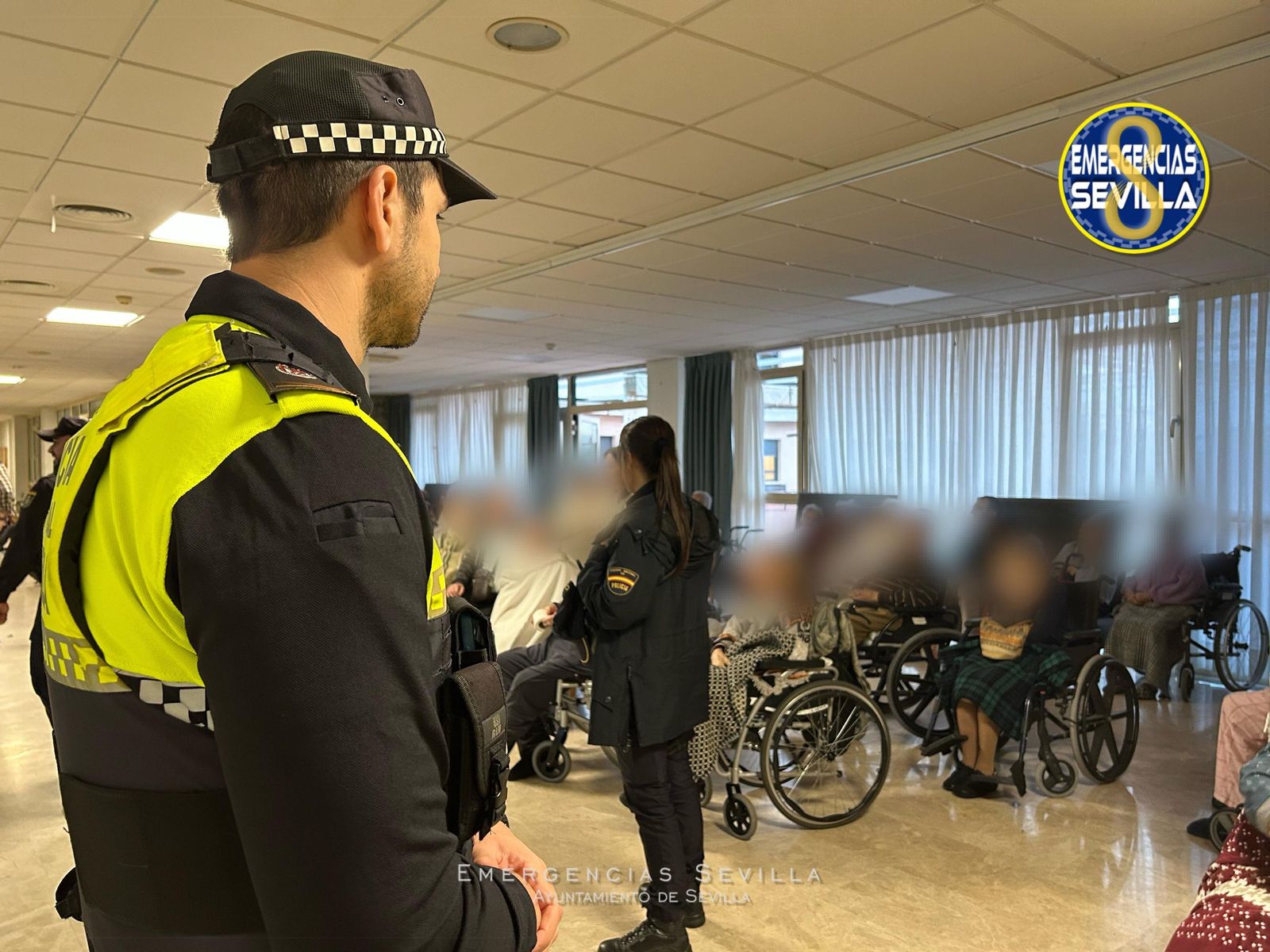 Dos policías, con varios ancianos evacuados.