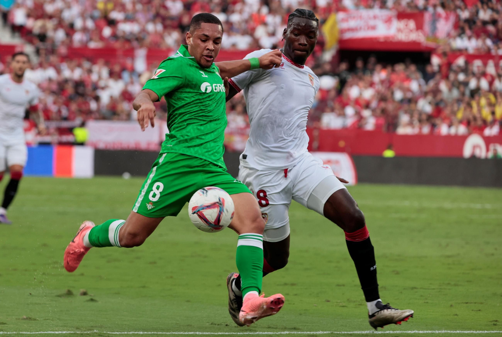 Vitor Roque intenta un disparo ante la presión de Agoumé.