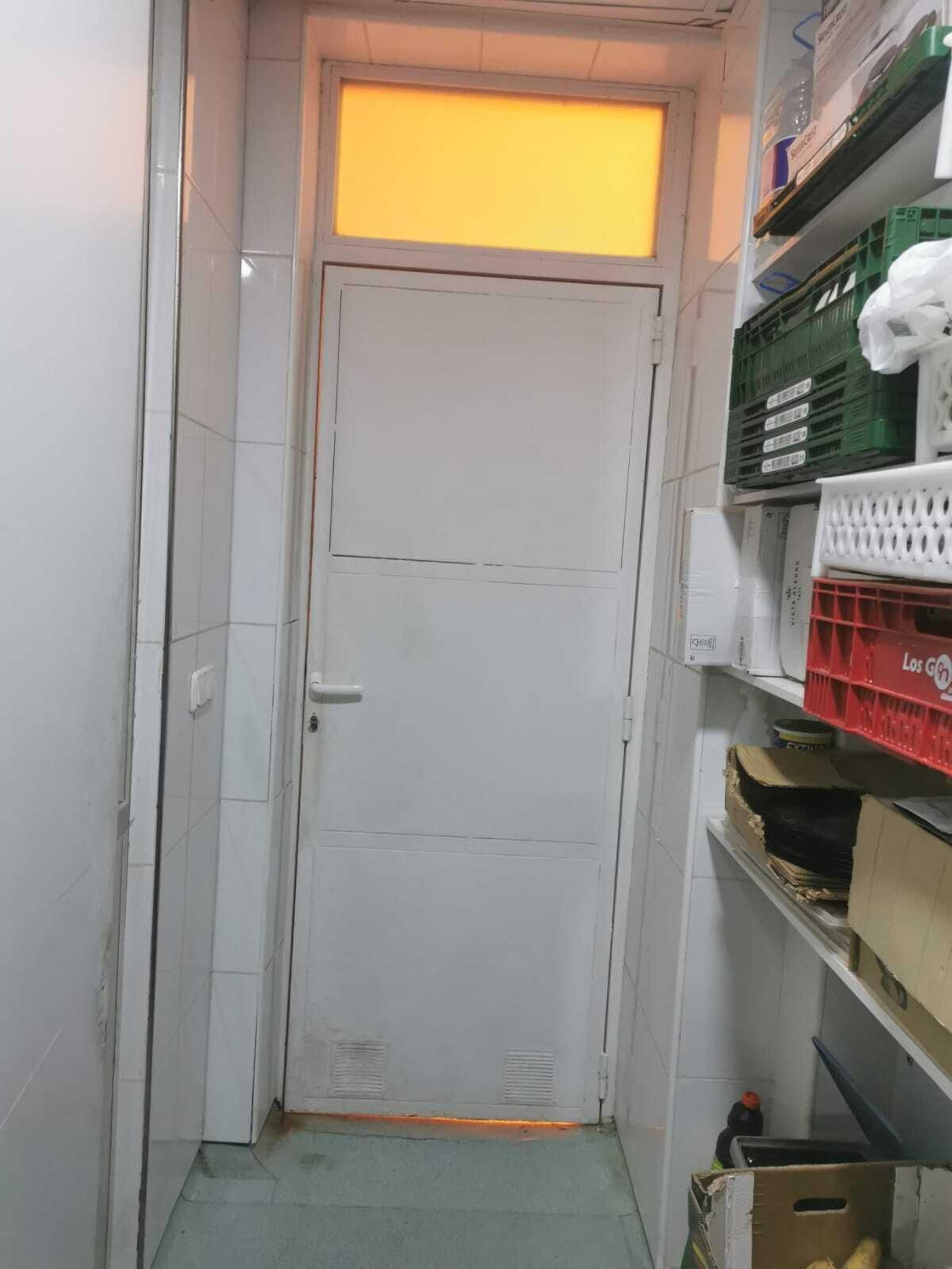 La luz naranja entra por el cristal de una puerta.