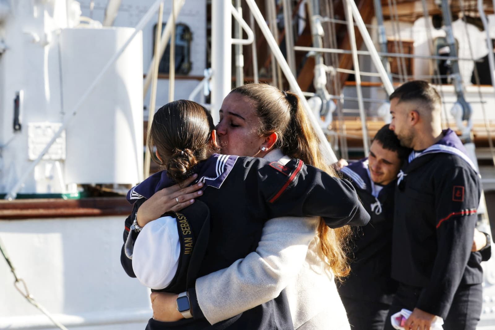 Un familiar abraza a una de las tripulantes del Juan Sebastián de Elcano antes de iniciar este sábado en Cádiz el 98 crucero de instrucción.