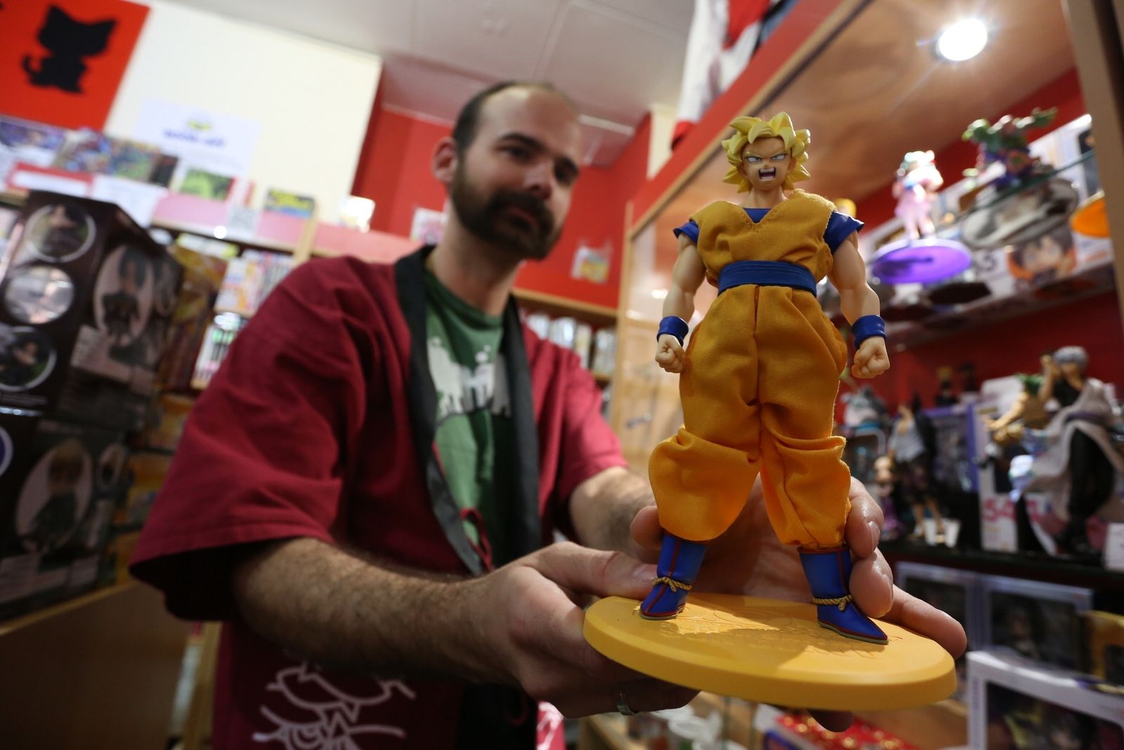 Fernando Castaño, de la tienda Arigatô, con una figura de Goku.