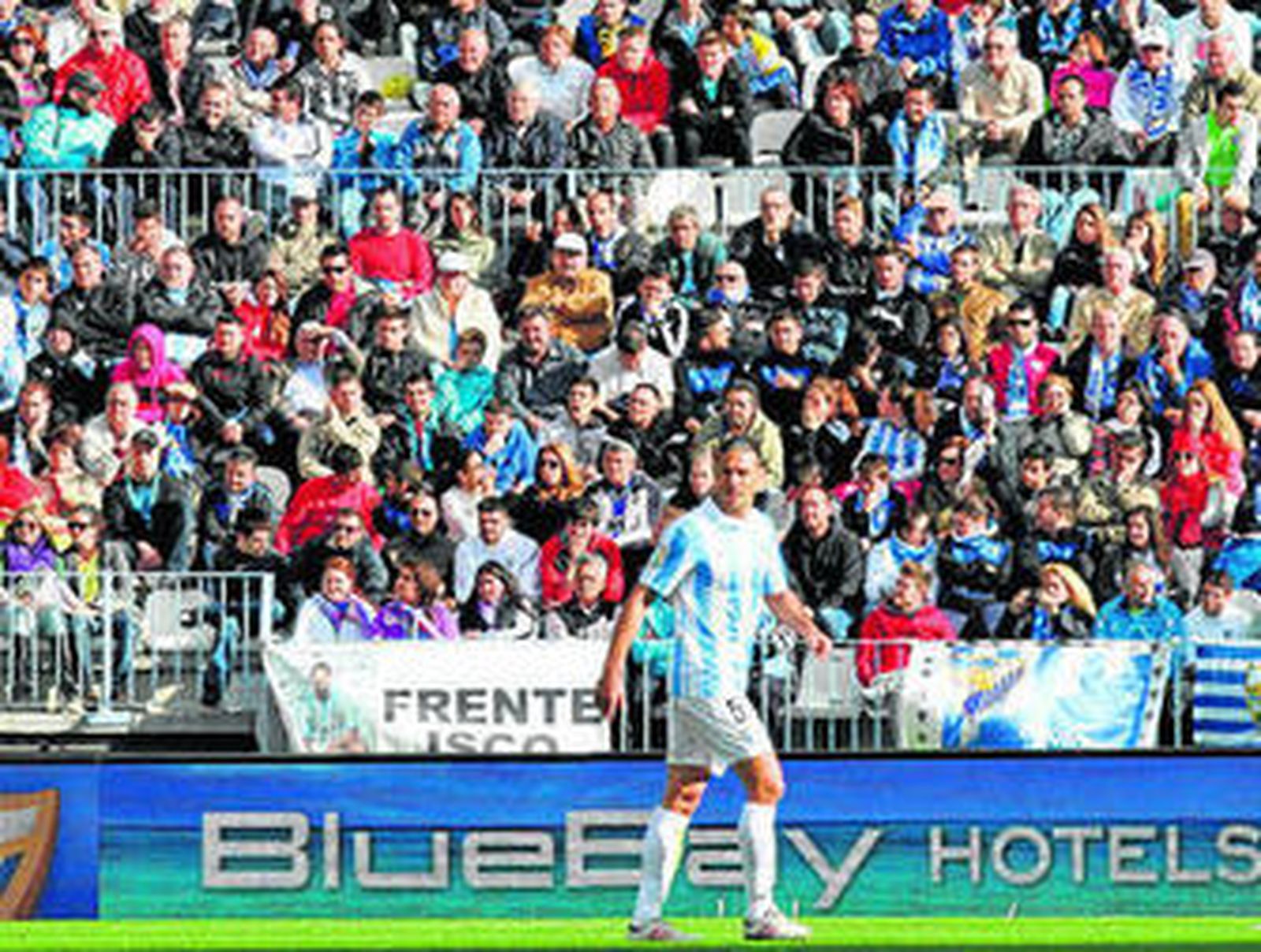 Demichelis observa un lance del juego con la publicidad de BlueBay Hoteles al fondo.