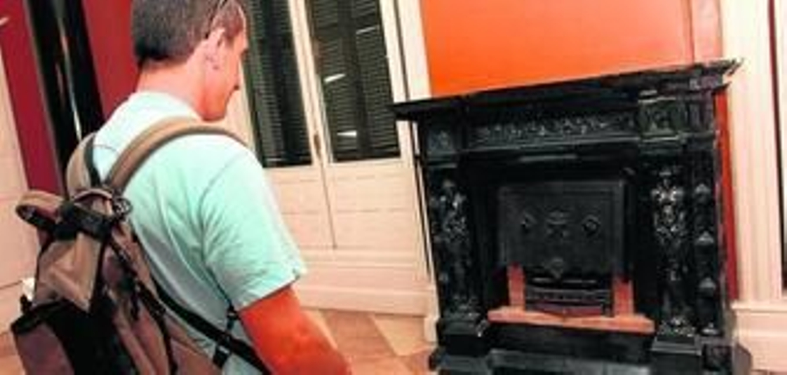 Un visitante observa los detalles de la lujosa decoración de uno de los salones.