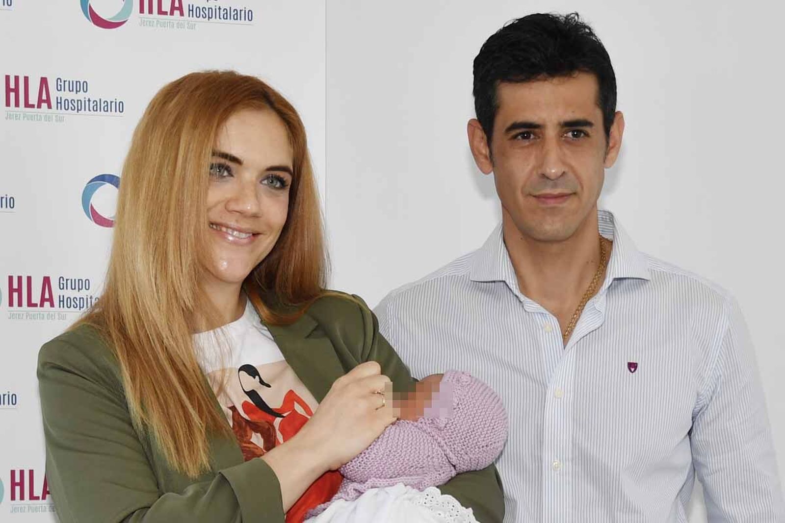 Víctor Janeiro y Beatriz Trapote posan a las puertas del hospital con su hija, Brenda.