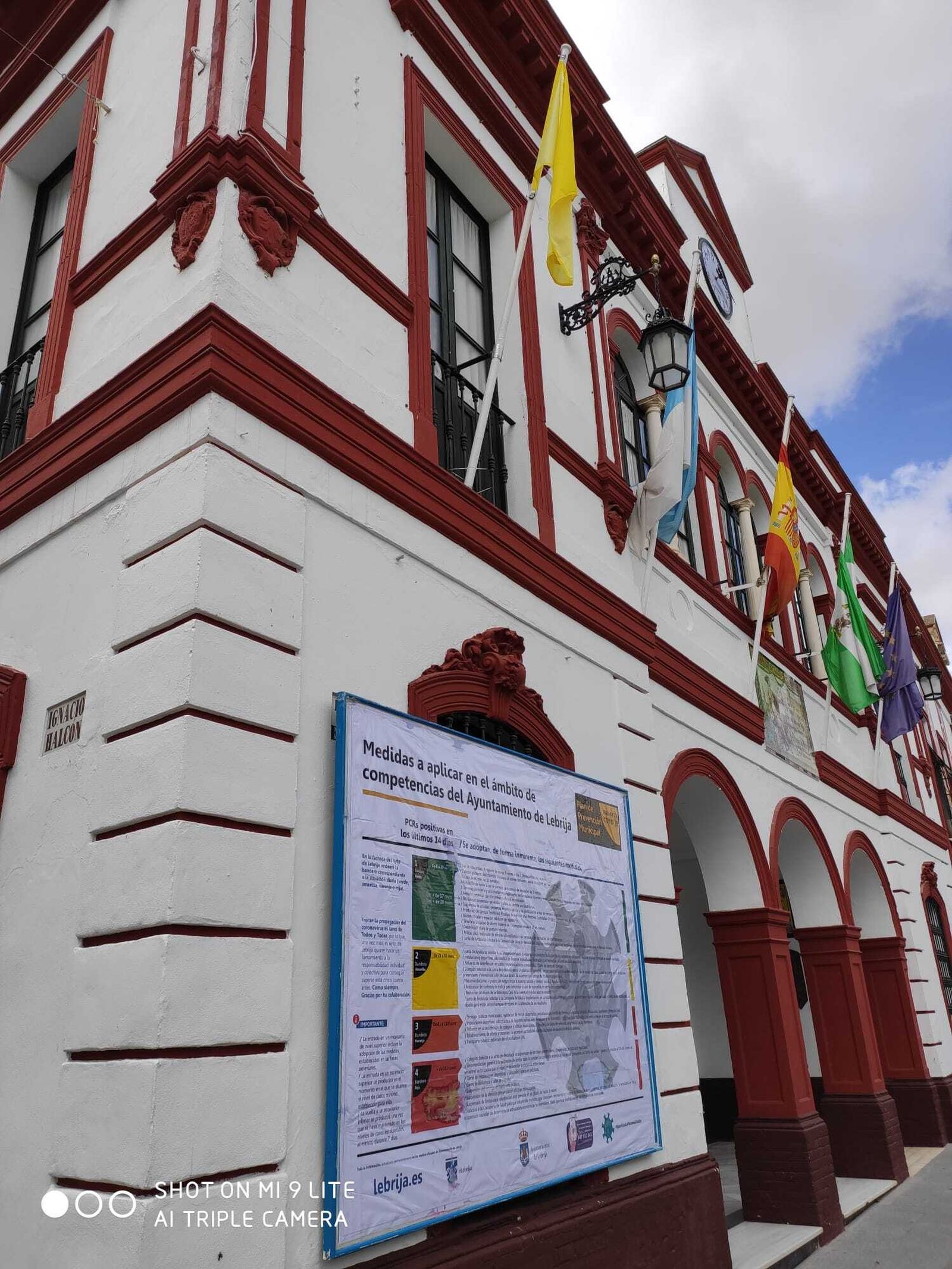 La bandera amarilla (que indica que los contagios han repuntado por endima de los 29) colocada ya en la fachada del Ayuntamiento de Lebrija.
